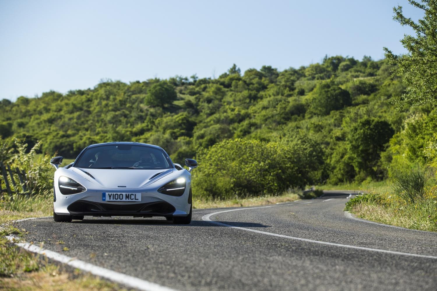 Silver McLaren 720S cornering on country road
