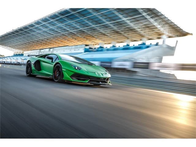Head To Head: Lamborghini Aventador Svj Vs. Mclaren 720S 7 Green lamborghini aventador svj racing down track