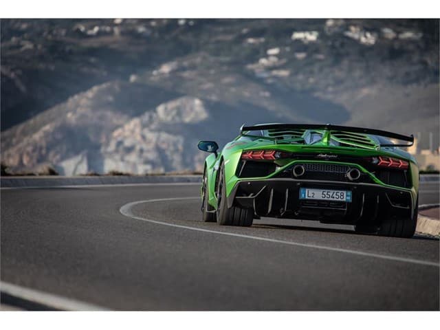 Head To Head: Lamborghini Aventador Svj Vs. Mclaren 720S 9 Rear view of green lamborghini aventador svj on road