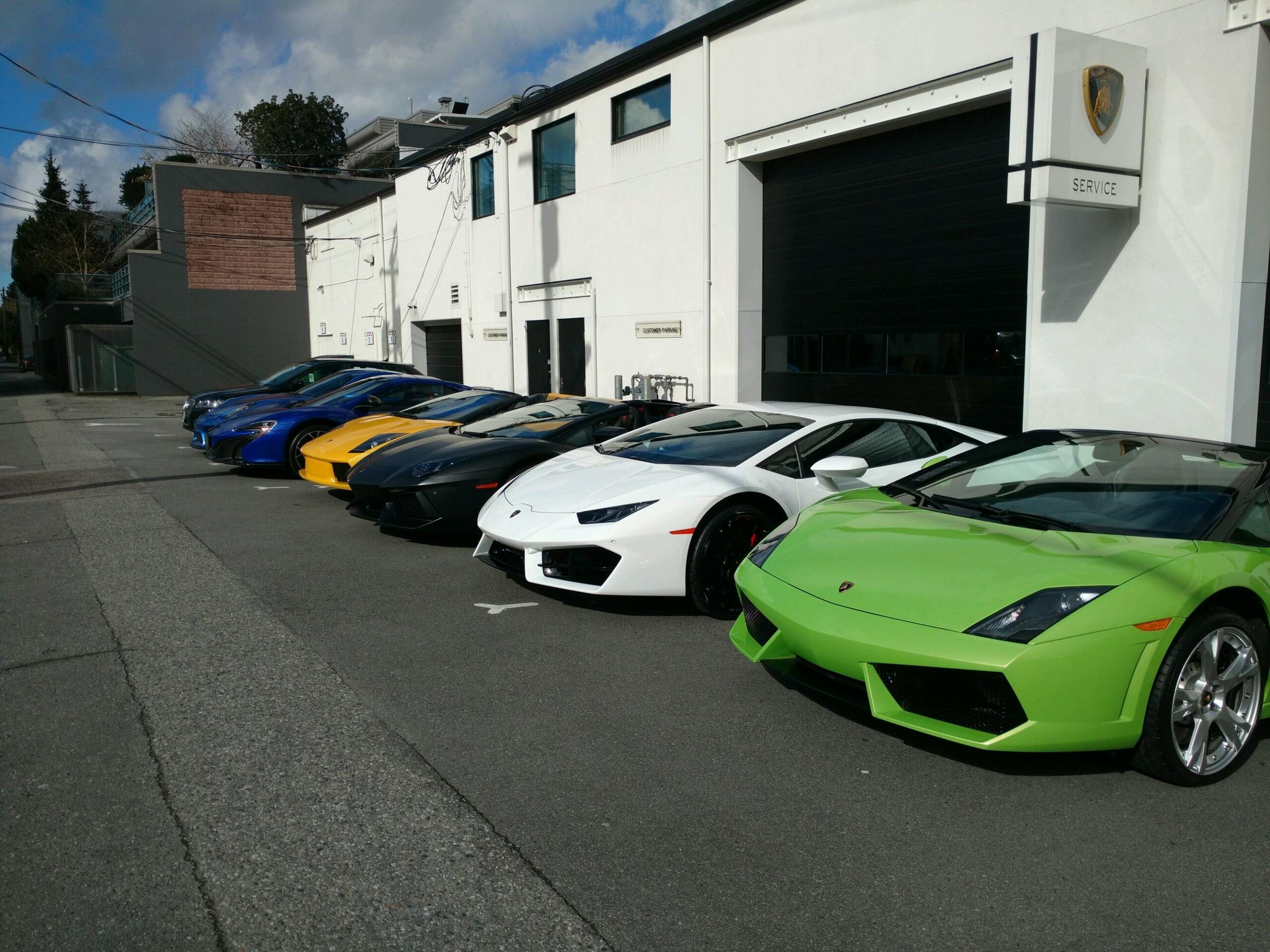 Lamborghinis parked outside a service bay