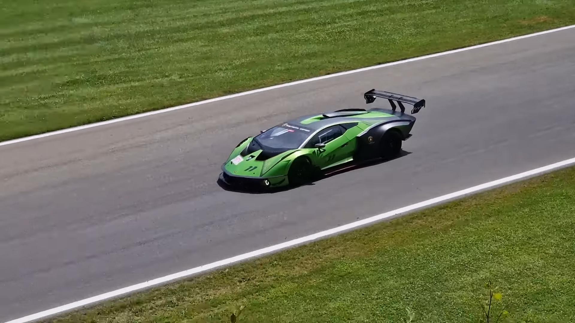 Lamborghini Essenza SCV12 in a vibrant green and dark grey livery, accelerating on a race track.