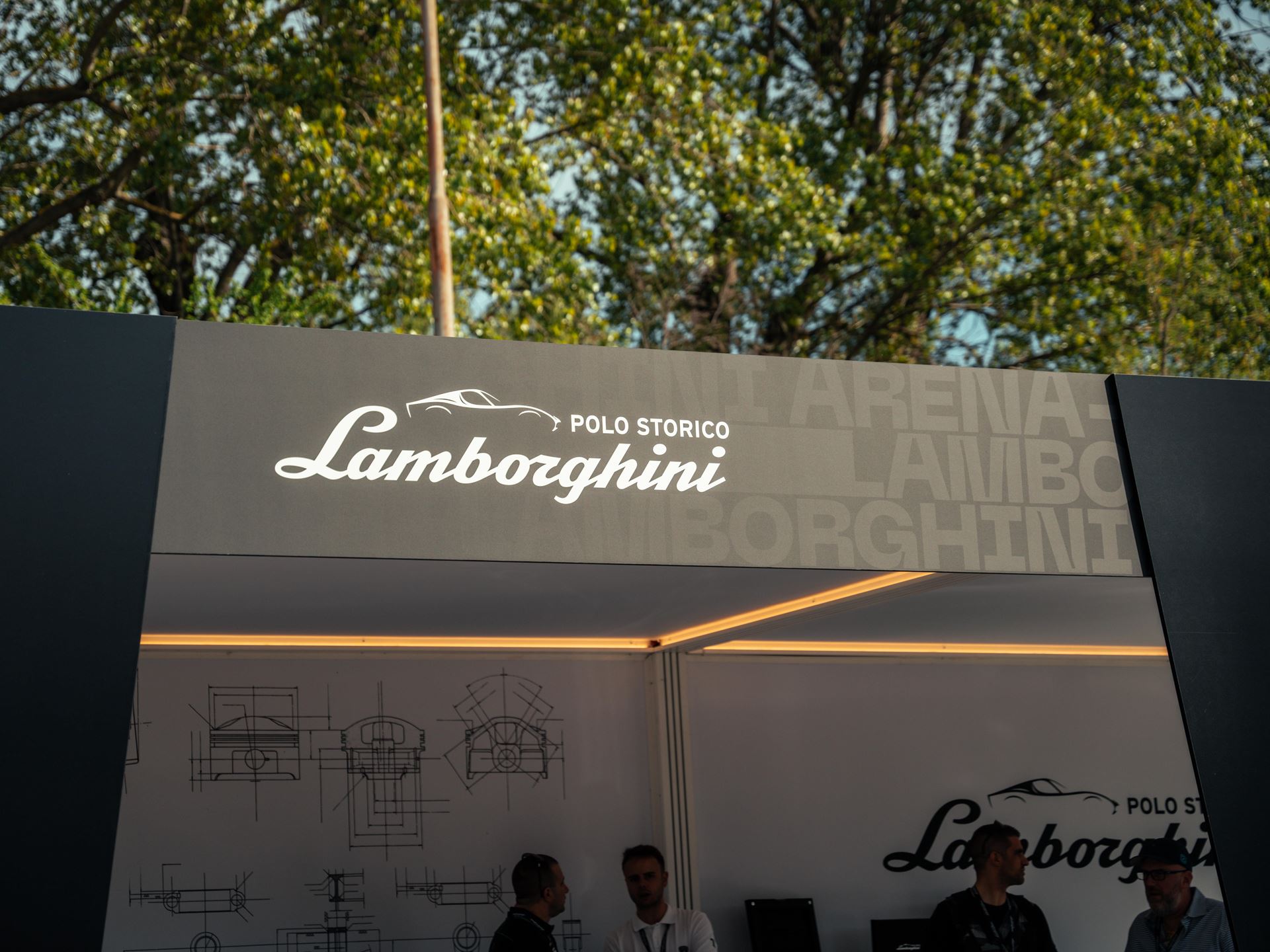 Lamborghini Arena 2026 Brings Live Super Trofeo Racing To Imola, Plus The Temerario Race Car'S Public Debut 3 Lamborghini polo storico sign at the arena event with engineering blueprints on the wall and visitors gathered below