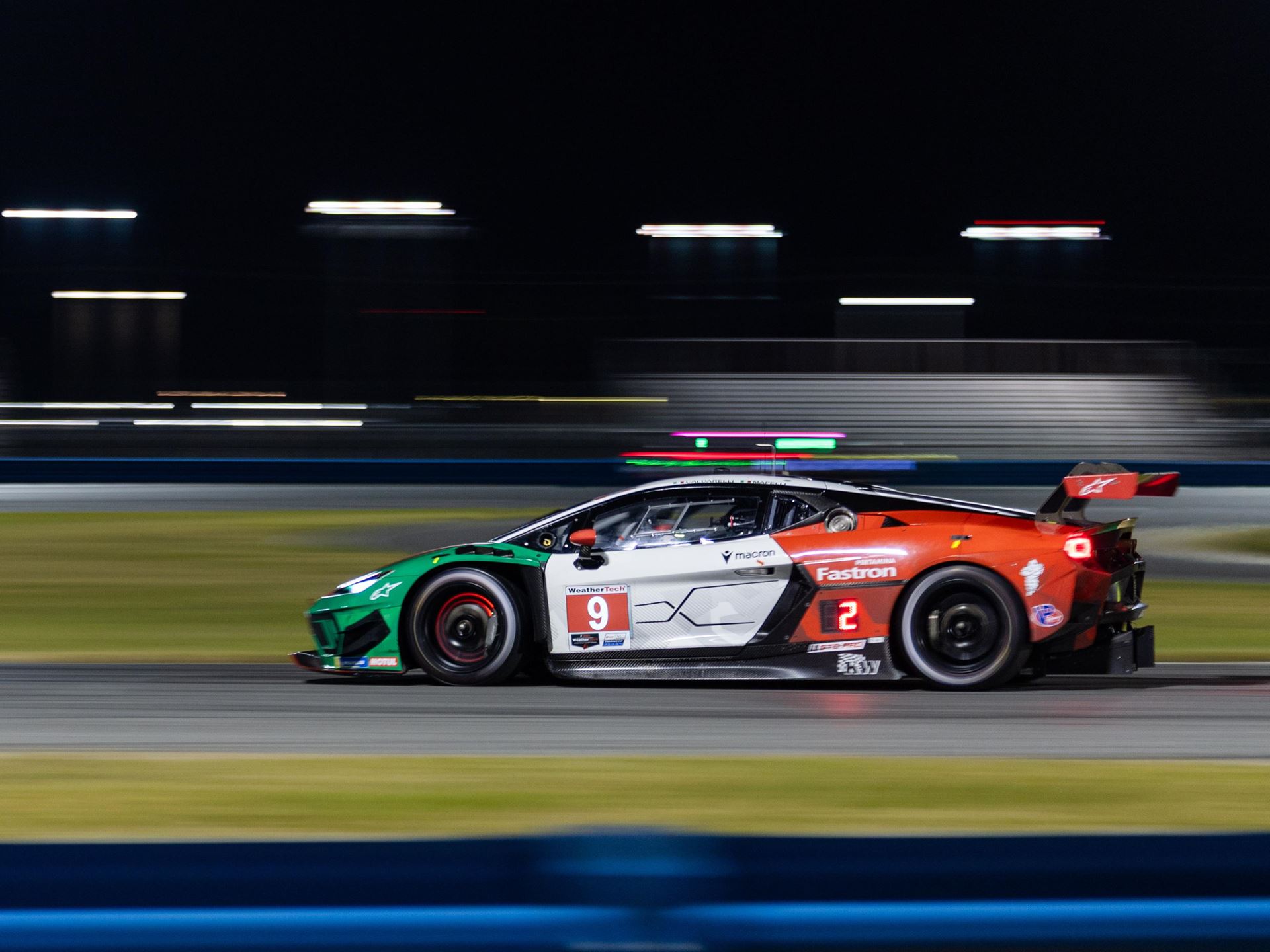 Lamborghini'S First In-House Gt3 Car Faces Brutal Sebring Debut 7 Lamborghini huracan gt3 evo race car number 9 at night on race track illuminated by track lights with motion blur and green, white, red livery
