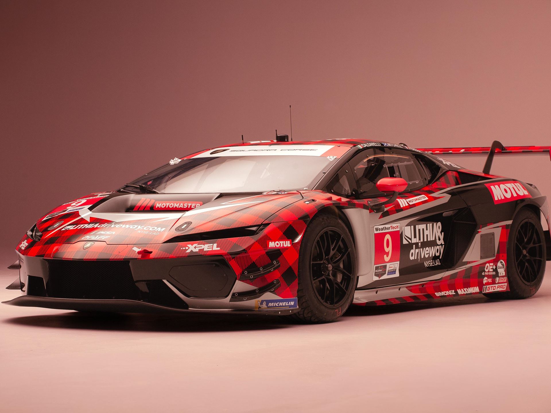 Lamborghini'S First In-House Gt3 Car Faces Brutal Sebring Debut 5 Lamborghini huracan gt3 evo race car number 9 front three-quarter view in studio with black and red plaid livery showing aggressive front splitter