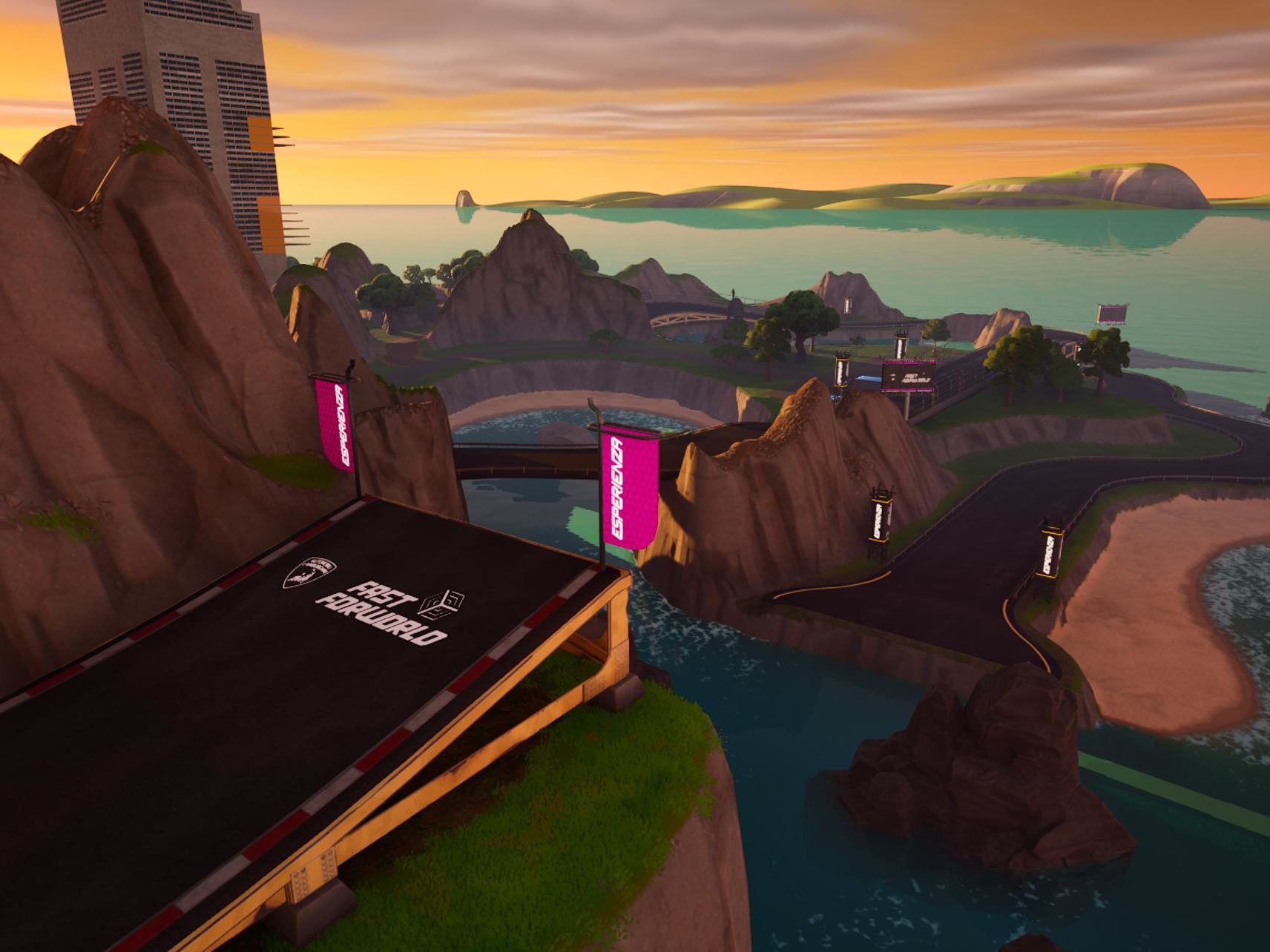 Elevated fast forworld branded race track section winding through coastal landscape
