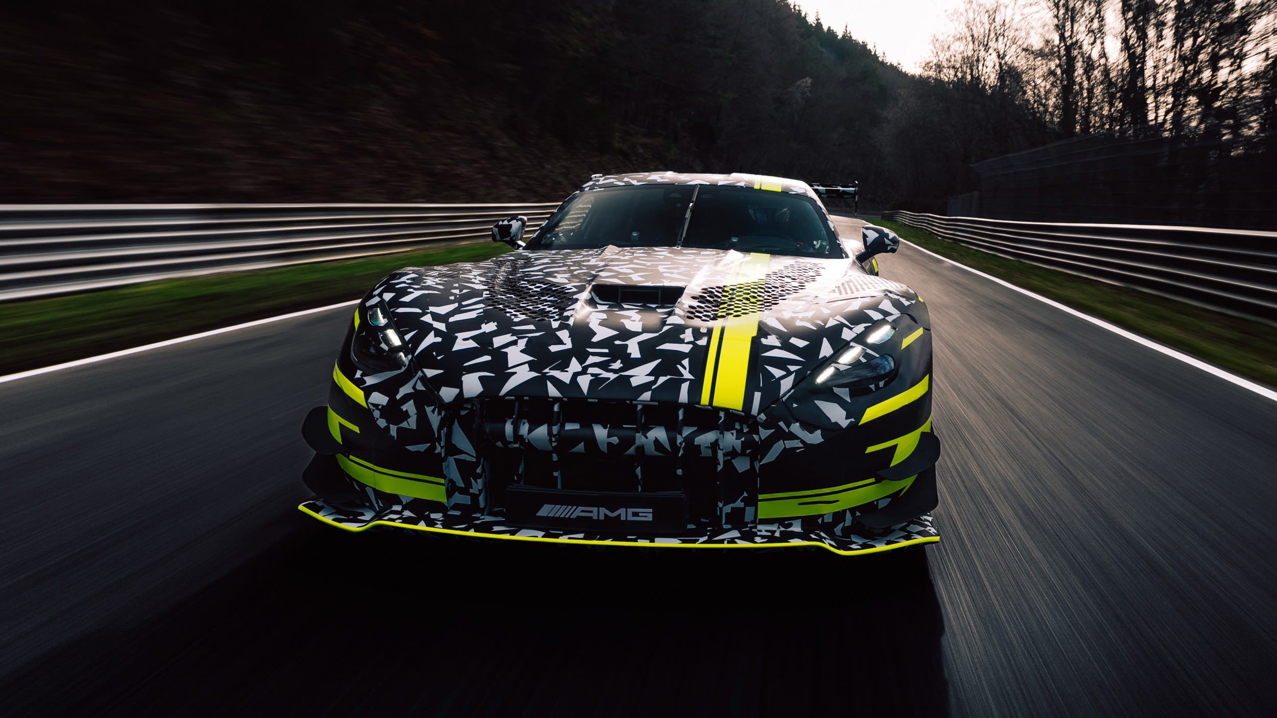 Amg'S Next Gt Black Series Is A Gt3 Homologation Special, And Lamborghini'S Temerario Program Should Take Notice 5 Camouflaged mercedes-amg gt black series prototype on track showing large rear wing and aerodynamic bodywork details under yellow-green livery