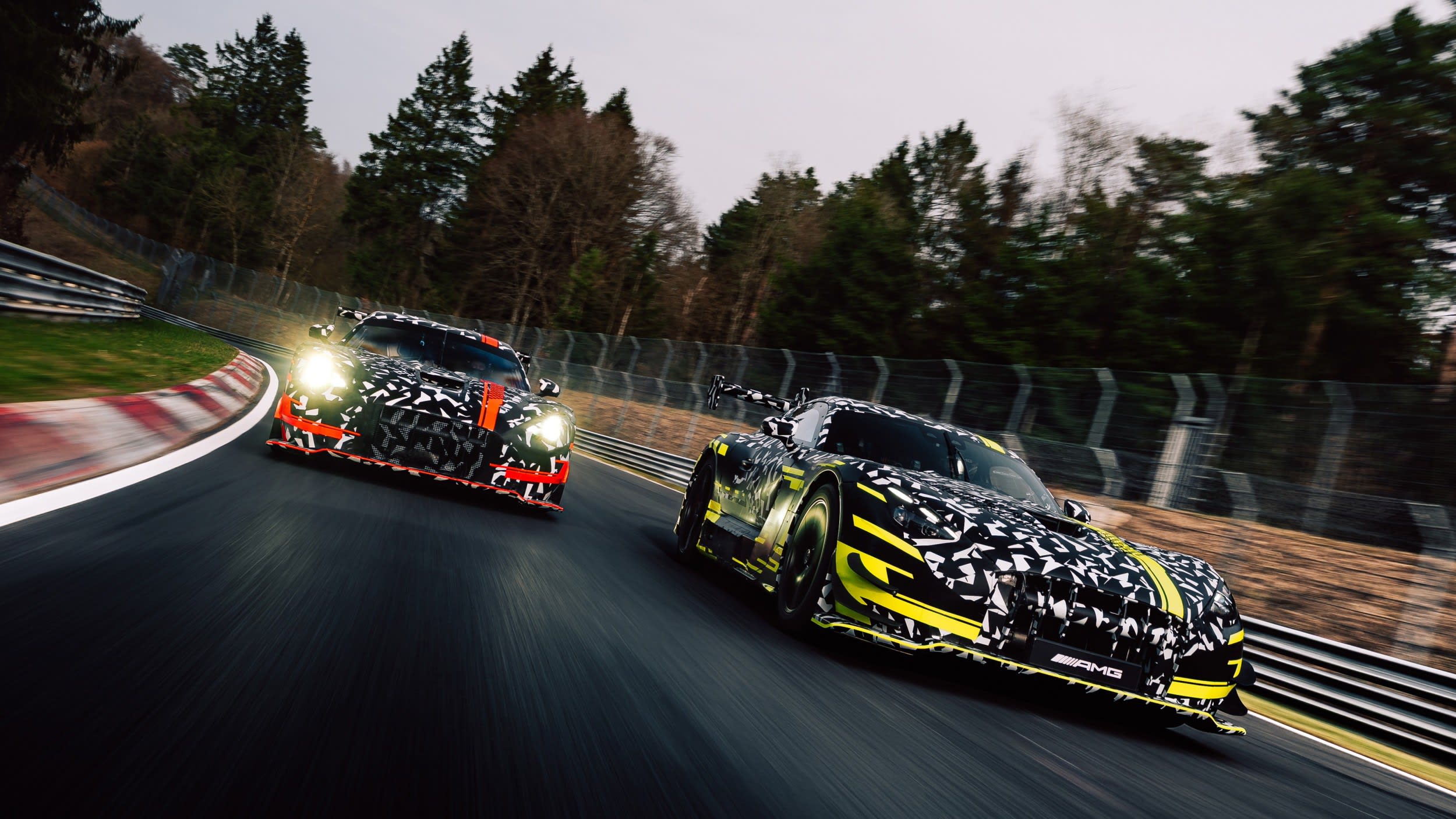 Amg'S Next Gt Black Series Is A Gt3 Homologation Special, And Lamborghini'S Temerario Program Should Take Notice 7 This image does not contain a lamborghini. It shows two mercedes-amg gt test prototypes in camouflage livery on a race track, with motion blur indicating speed.