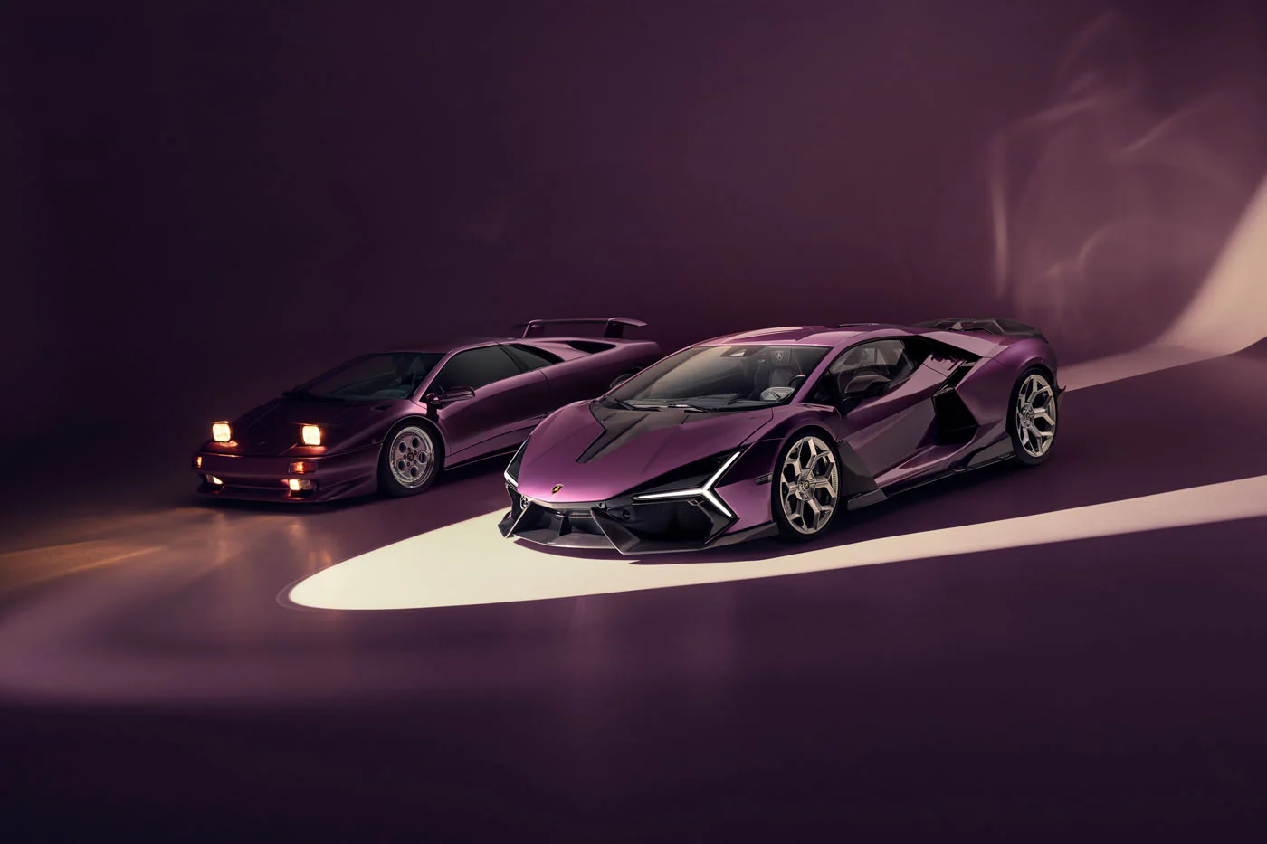 Novitec'S 1,048 Hp Revuelto Program: What It Offers That Lamborghini'S Own Ad Personam Cannot 39 Two purple lamborghinis, a modern revuelto and a classic diablo, are posed together in a studio with dramatic lighting. The image highlights the evolution of lamborghini's design language, showcasing