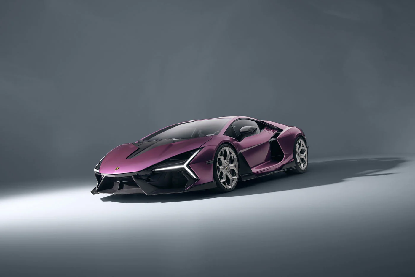Novitec'S 1,048 Hp Revuelto Program: What It Offers That Lamborghini'S Own Ad Personam Cannot 15 A striking purple lamborghini revuelto is showcased in a studio setting, highlighting its aggressive front fascia and sharp lines. The car's modern design is emphasized by the clean, minimalist backgr