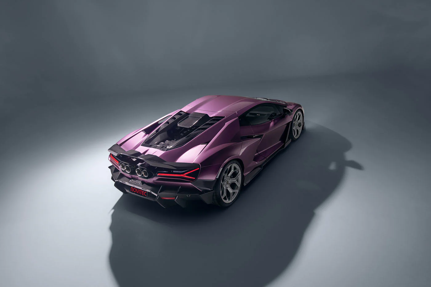 Novitec'S 1,048 Hp Revuelto Program: What It Offers That Lamborghini'S Own Ad Personam Cannot 9 Top-down rear view of a purple novitec lamborghini revuelto showing exposed engine bay, rear diffuser, exhaust outlets, and novitec badging