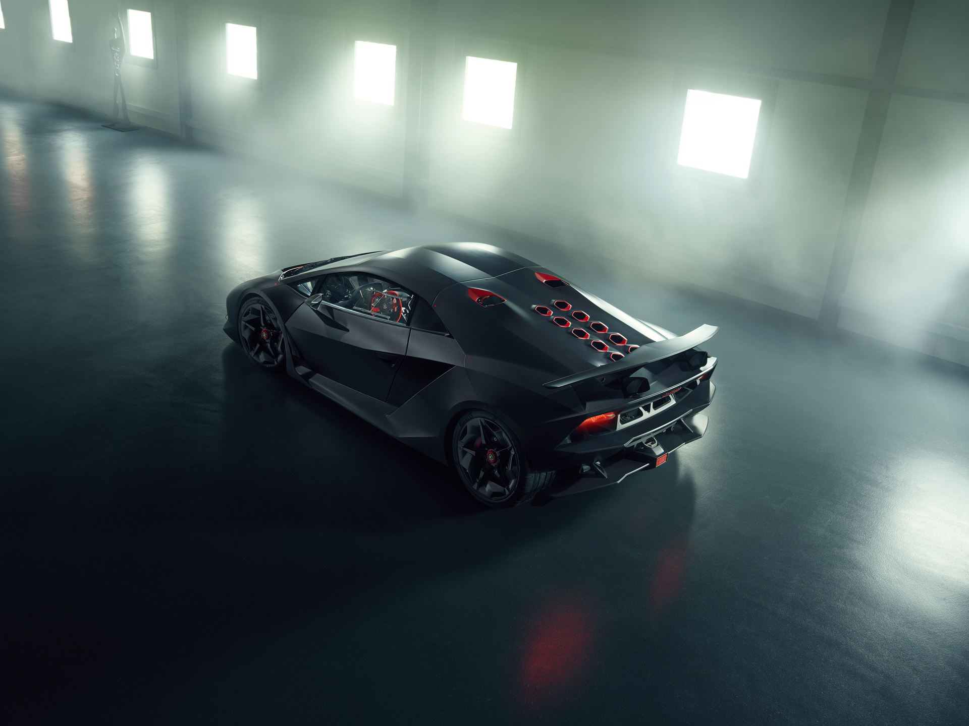 The Sesto Elemento Weighs 999 Kilograms. Some Owners Actually Drive Theirs On Public Roads. 9 High-angle rear three-quarter view of the lamborghini sesto elemento showing hexagonal engine vents, rear wing, and diffuser