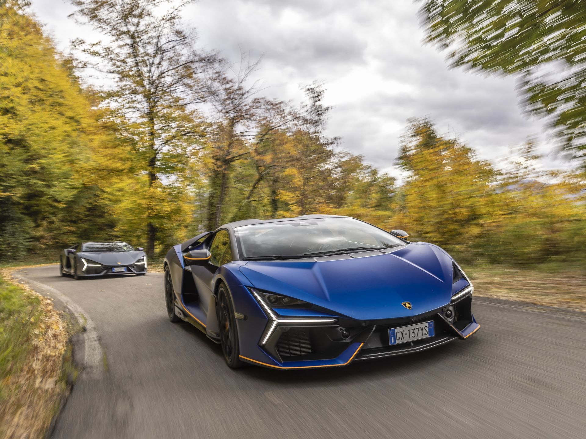 Two blue temerario models driving on winding road demonstrating performance