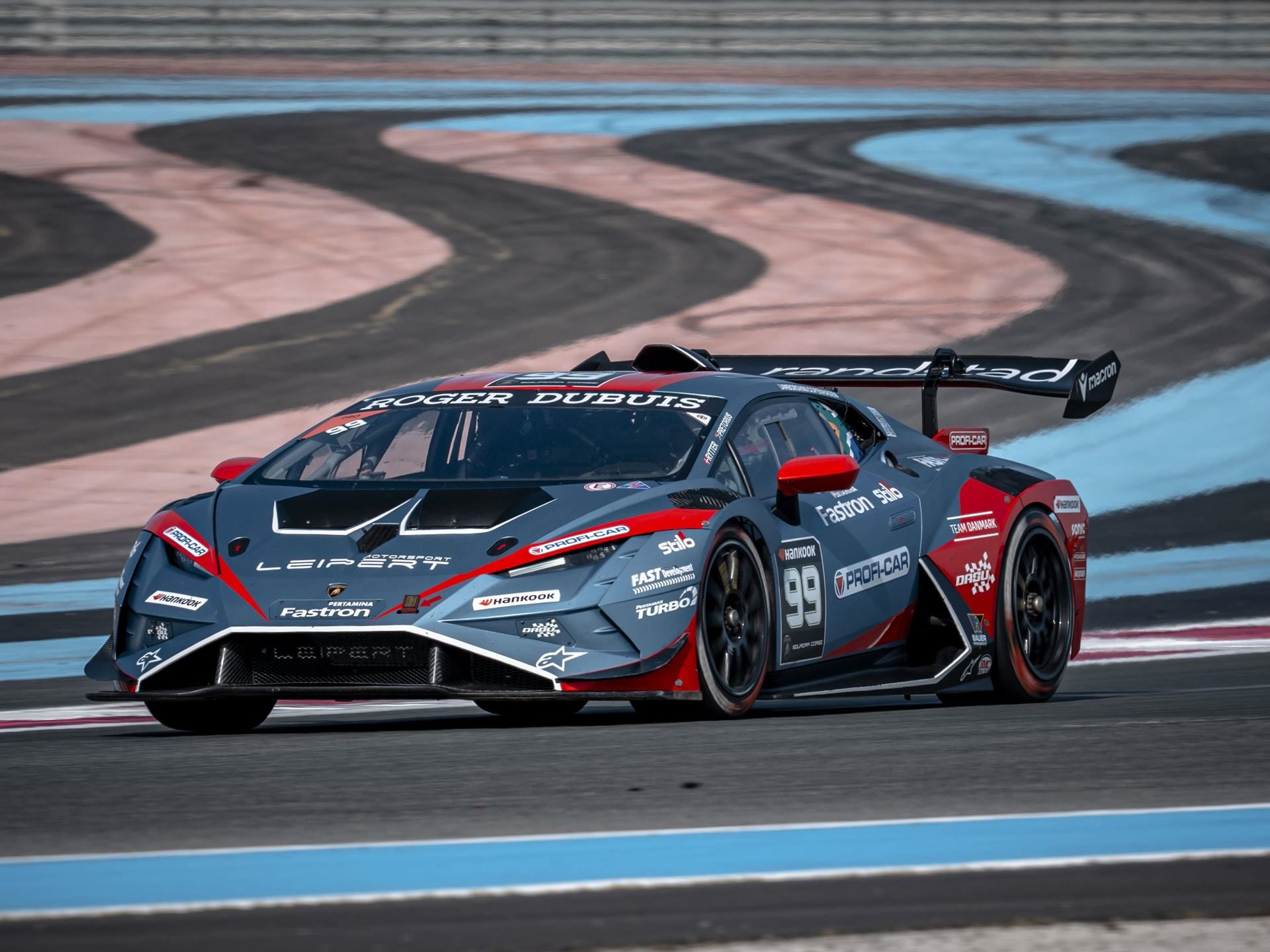 30 Huracán Super Trofeo Evo2S Hit Paul Ricard This Weekend As Lamborghini'S V10 One-Make Series Enters Year 18 5 A grey and red lamborghini huracán race car number 99 mid-corner at circuit paul ricard with large rear wing and front canards visible