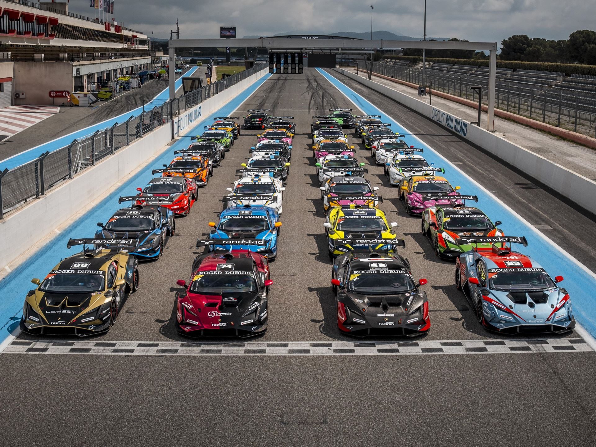 30 Huracán Super Trofeo Evo2S Hit Paul Ricard This Weekend As Lamborghini'S V10 One-Make Series Enters Year 18 9 Aerial overhead view of a vast array of lamborghini huracán race cars arranged in rows on the circuit paul ricard grid with colorful liveries