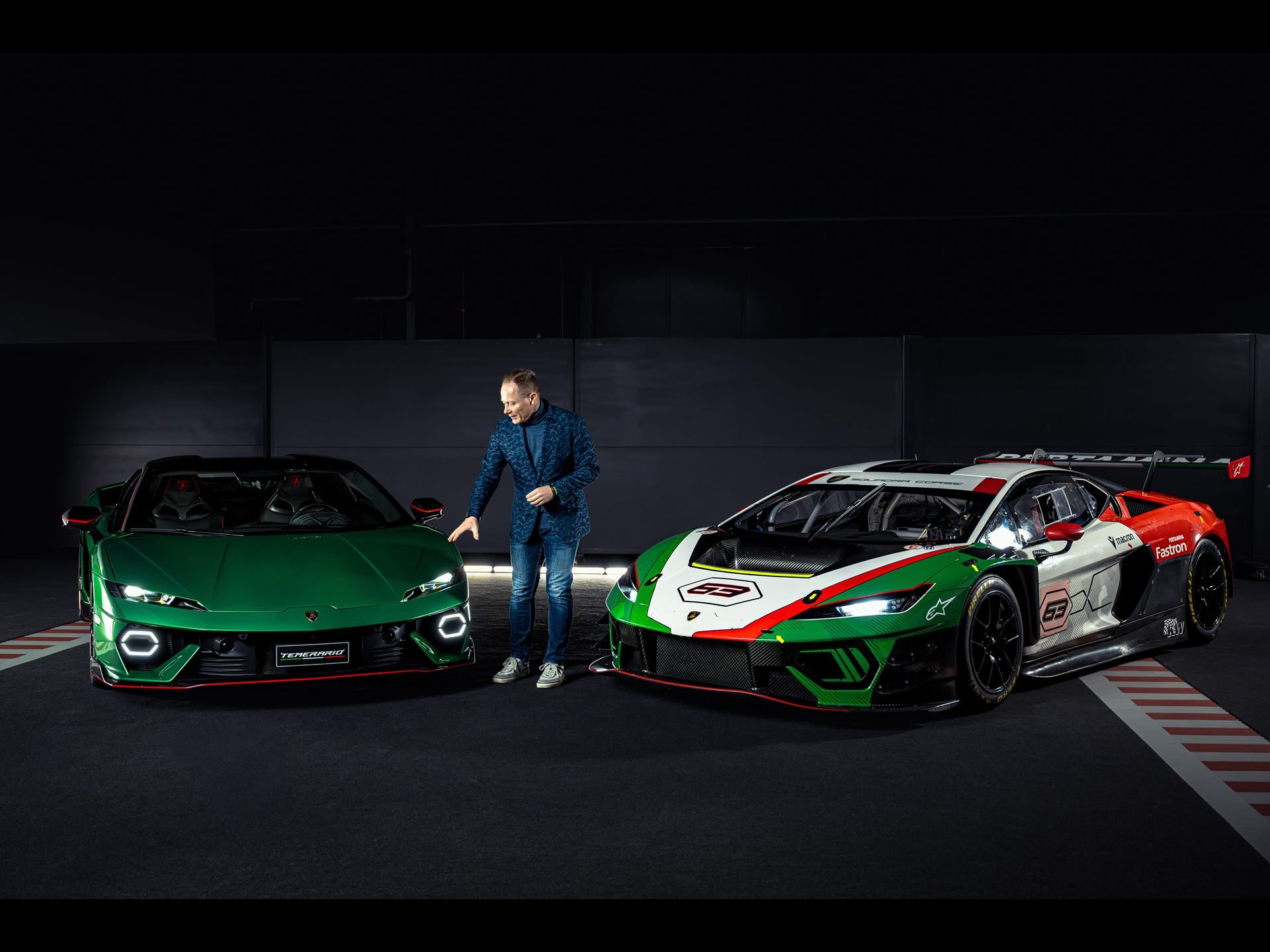 Mitja borkert standing between the green lamborghini temerario road car and the gt3 race car, with visible roll cage and carbon fiber components on the gt3