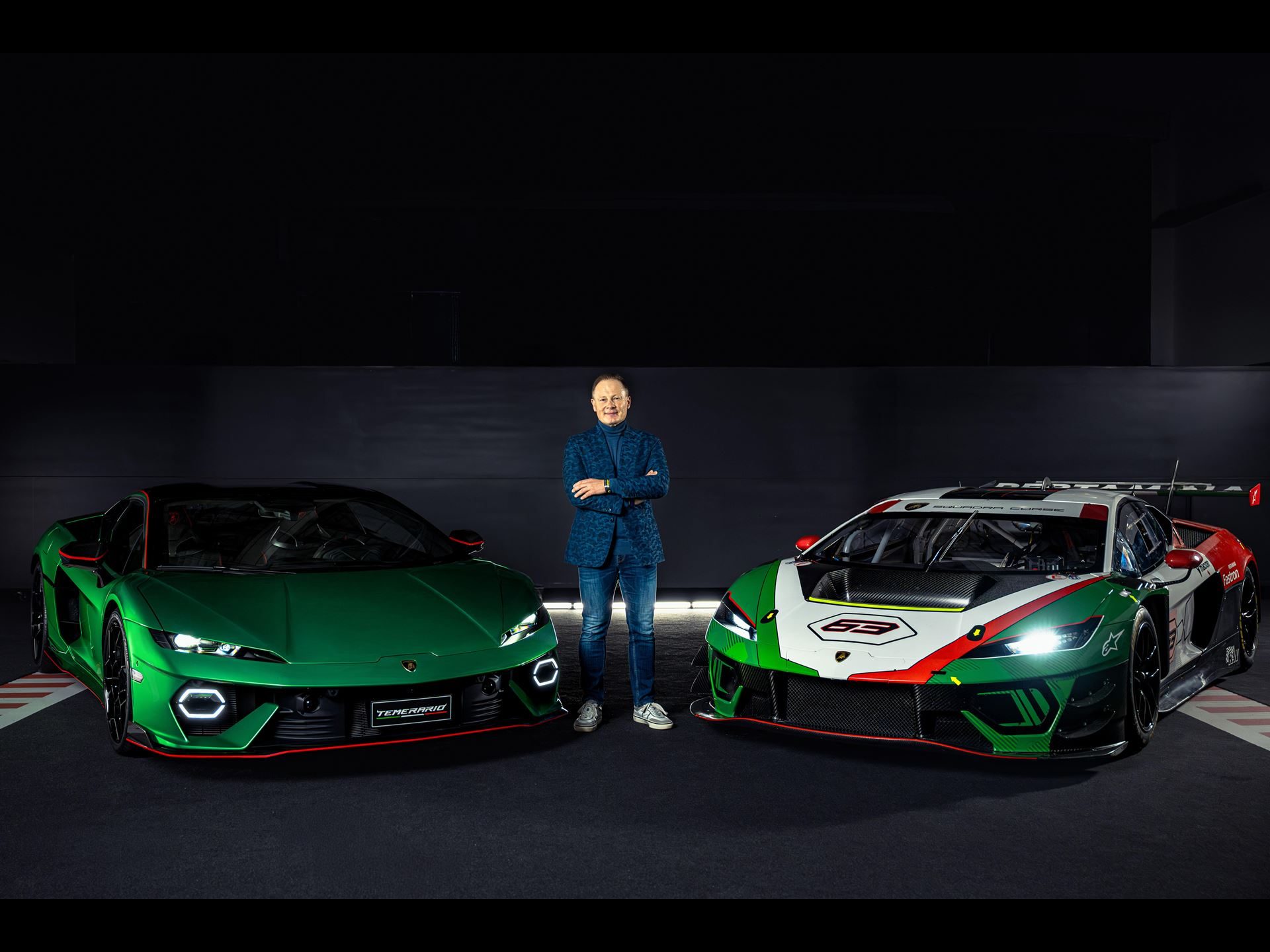 Mitja borkert standing between the lamborghini temerario road car and gt3 race car, both facing forward, showing y-shaped drls on the road car