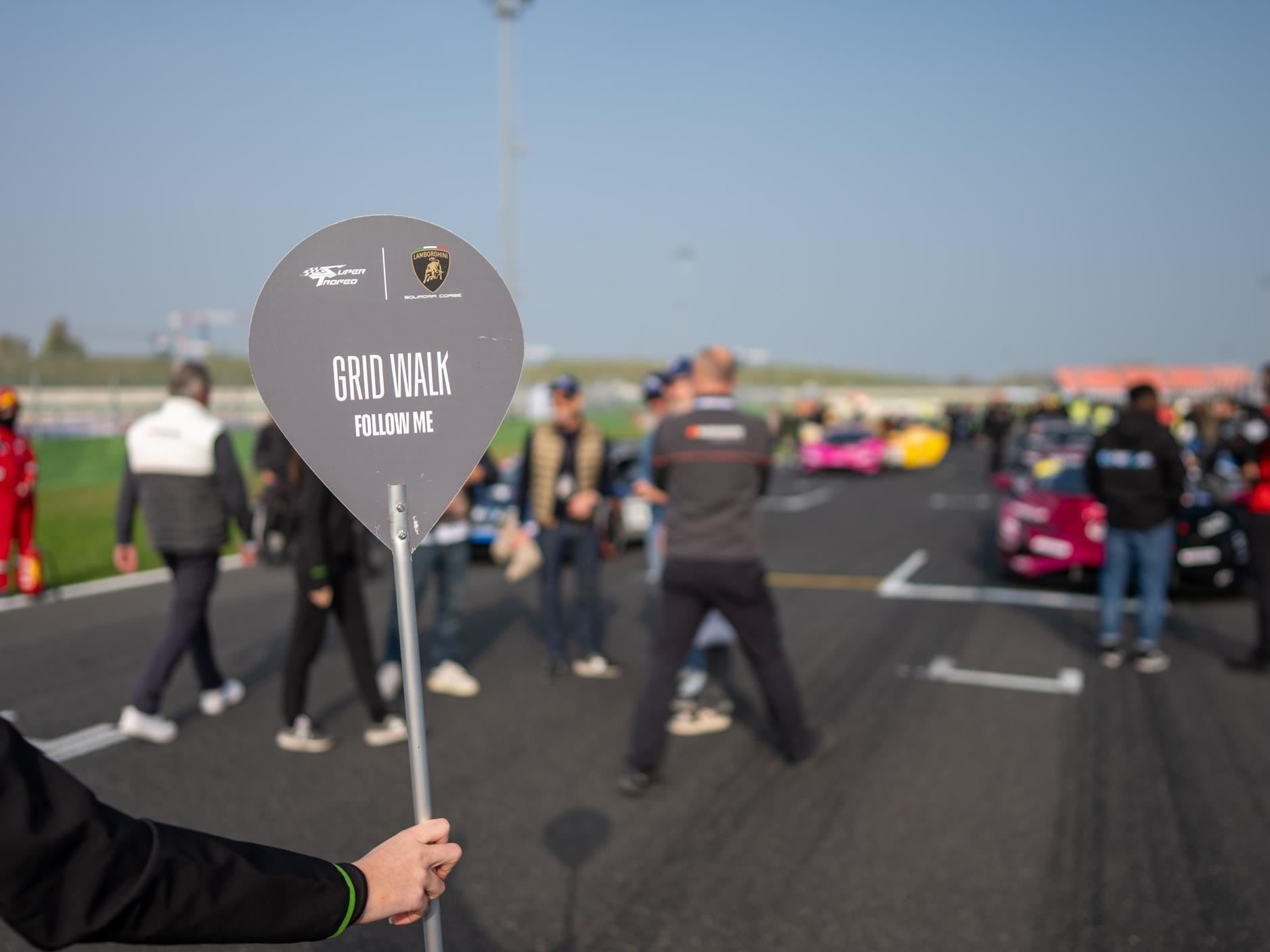 Eleven Winners, Seven Champions: The Huracán Super Trofeo Evo2'S Triumphant Farewell At Misano 9 Grid walk at the lamborghini world finals with squadra corse branding and spectators walking on the misano circuit