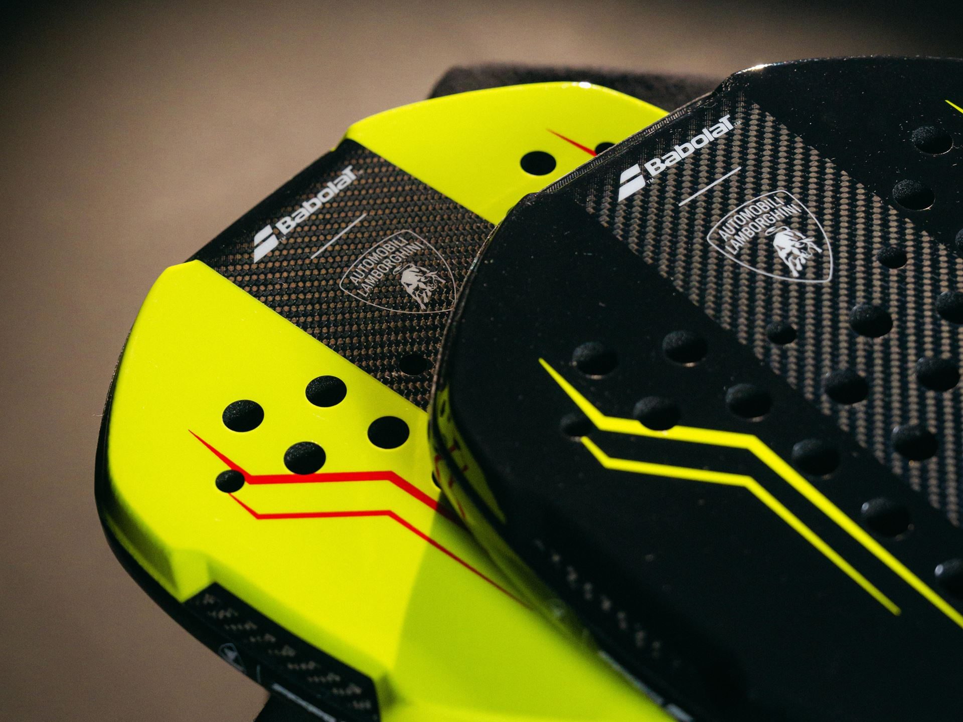 Babolat X Lamborghini Bl002: Carbon Fiber Expertise Meets The Padel Court At $650 3 Close-up of two babolat x lamborghini bl002 padel racquets in neon yellow and black showing carbon fiber texture and lamborghini logos
