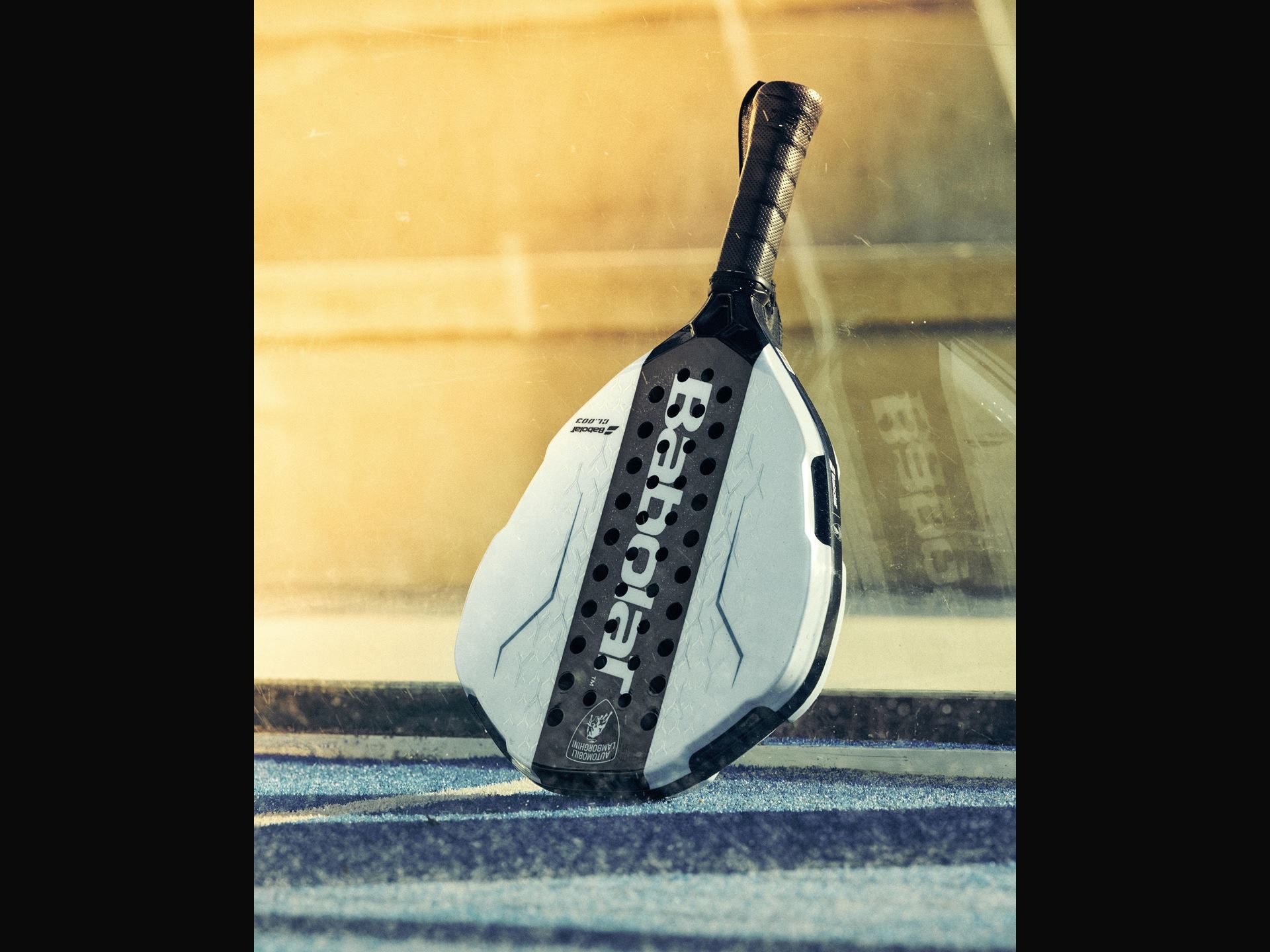 Lamborghini'S Koridion Foam Now Lives Inside A Padel Racquet: The Bl003 Explained 3 White babolat bl003 padel racquet with lamborghini logo resting on blue padel court near the net