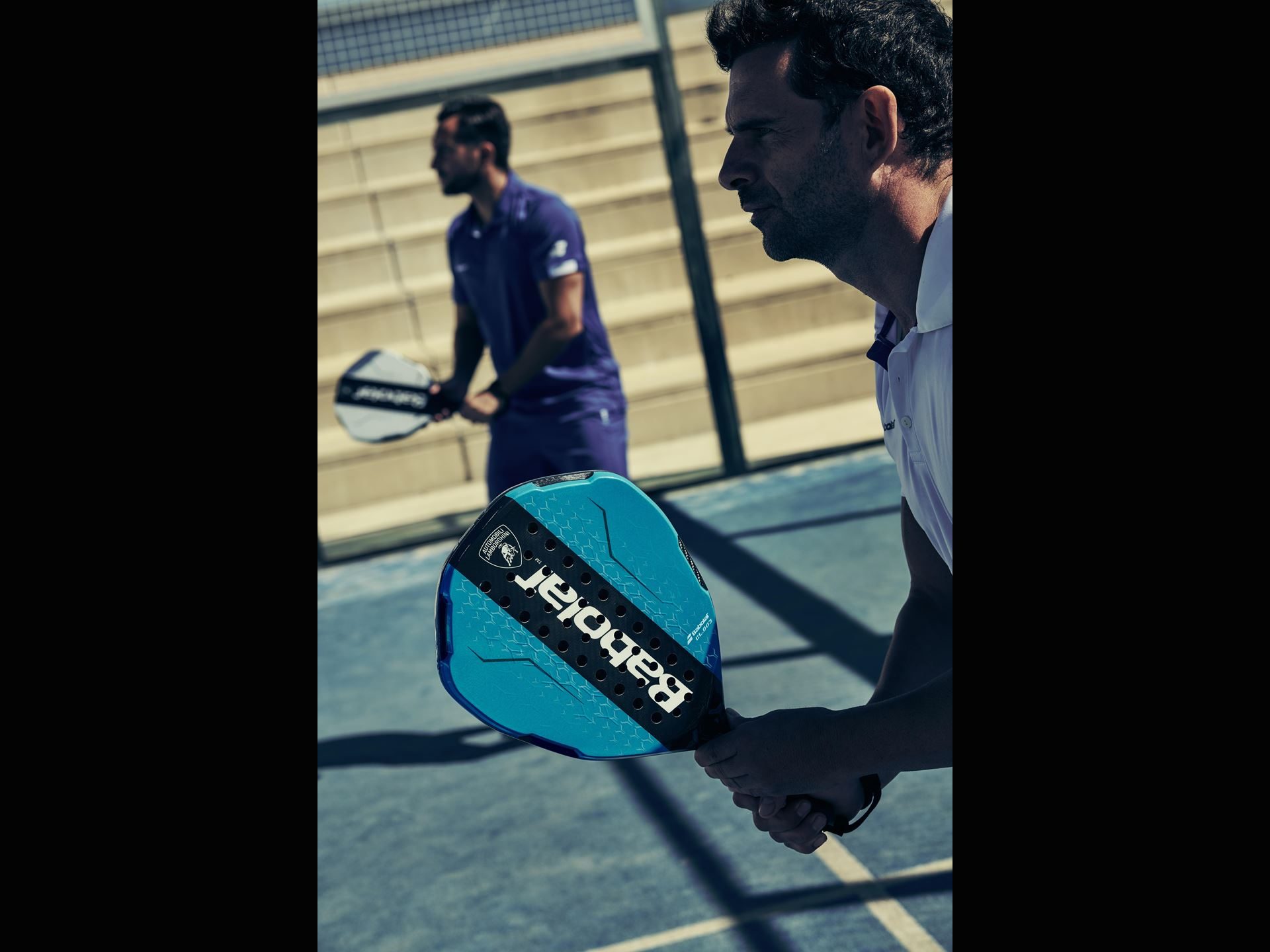 Lamborghini'S Koridion Foam Now Lives Inside A Padel Racquet: The Bl003 Explained 7 Player in white holding blue babolat bl003 padel racquet with lamborghini logo during padel match