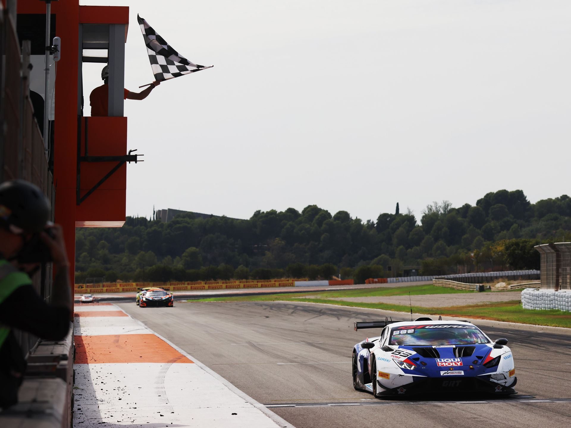 Huracán Gt3 Scores 197Th Win At Valencia As Lamborghini Prepares To Hand A Dynasty To The Temerario 7 Lamborghini huracán gt3 evo2 crosses the finish line under a checkered flag waved by a race official