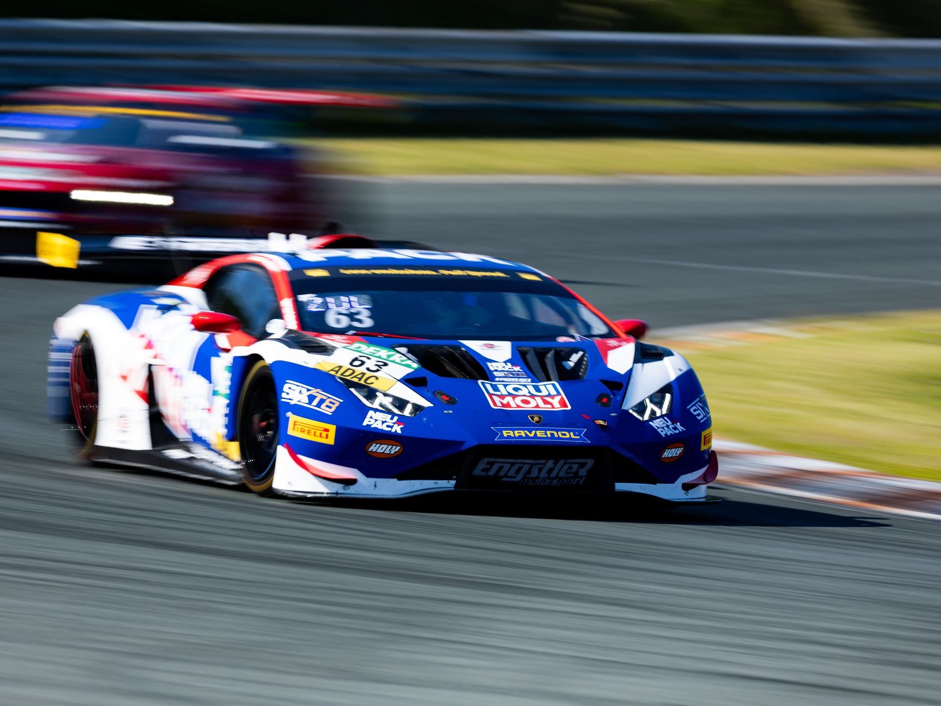 Huracán Gt3 Evo2 Wins Again At Zandvoort, Extends Lamborghini'S Adac Gt Masters Lead By 18 Points 5 The #63 lamborghini huracán gt3 evo at speed through a corner at zandvoort with motion blur emphasizing velocity