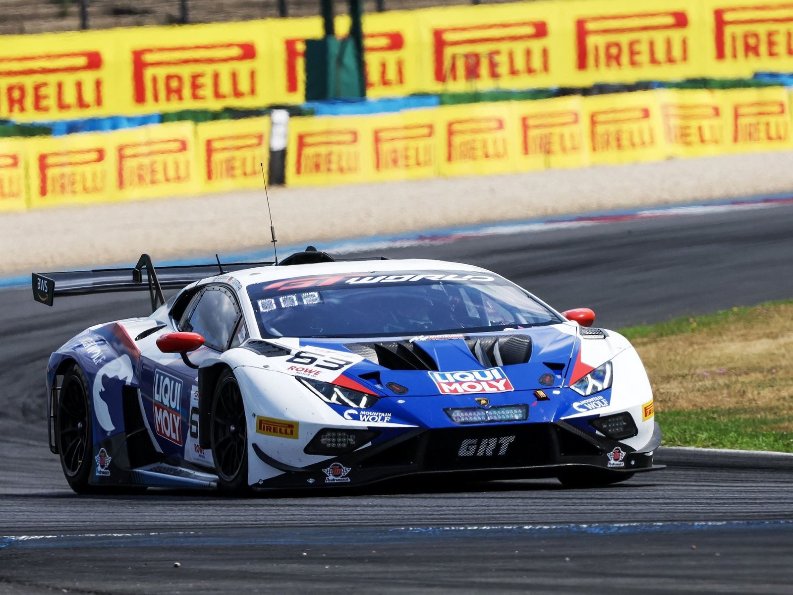 The #63 Grasser Racing Team Lamborghini Huracán GT3 EVO2 navigating a turn at Magny-Cours during the GT World Challenge Europe Sprint Cup