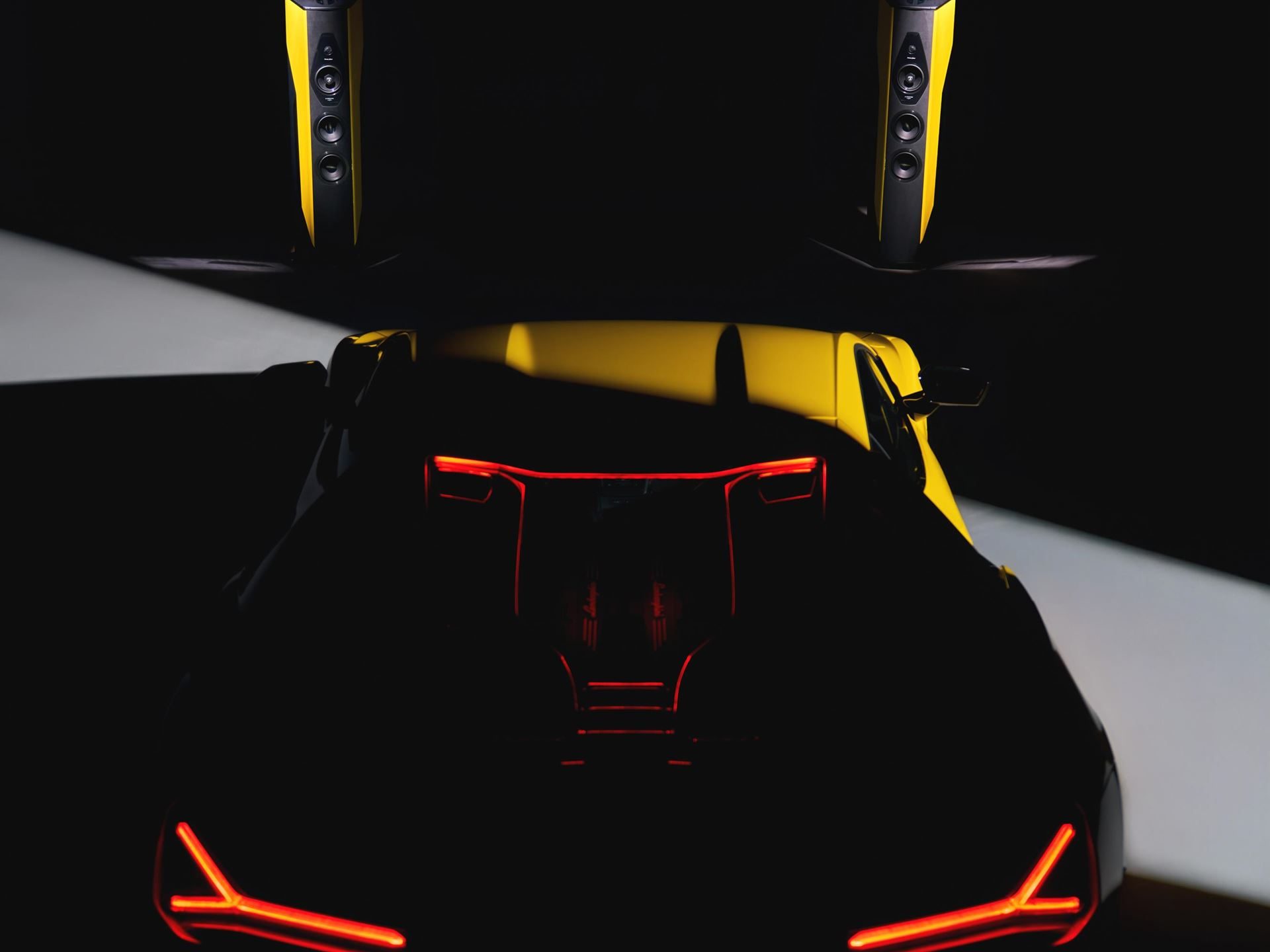 Lamborghini'S $130,000 Sonus Faber Speakers: What 50 Pairs And Five Paint Codes Reveal About The Brand'S Exclusivity Strategy 7 Overhead shot of the lamborghini revuelto rear with y-shaped taillights illuminated, flanked by two il cremonese ex3me lamborghini edition speakers