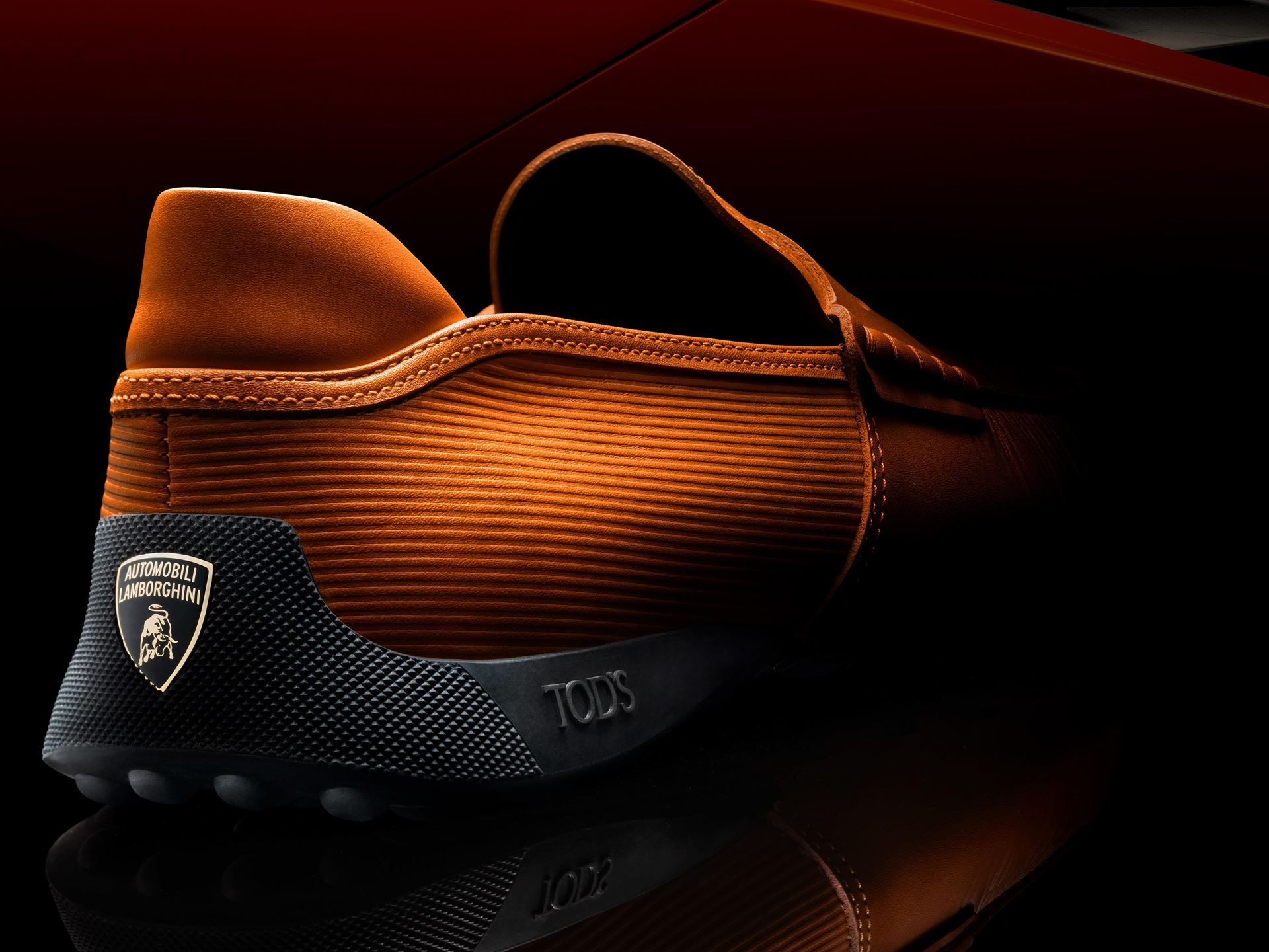 Lamborghini'S 2025 Holiday Gift Guide Stretches From Lego Bricks To $30,000 Loudspeakers 7 Close-up of a brown leather tod's driving shoe with lamborghini shield logo embossed on the heel