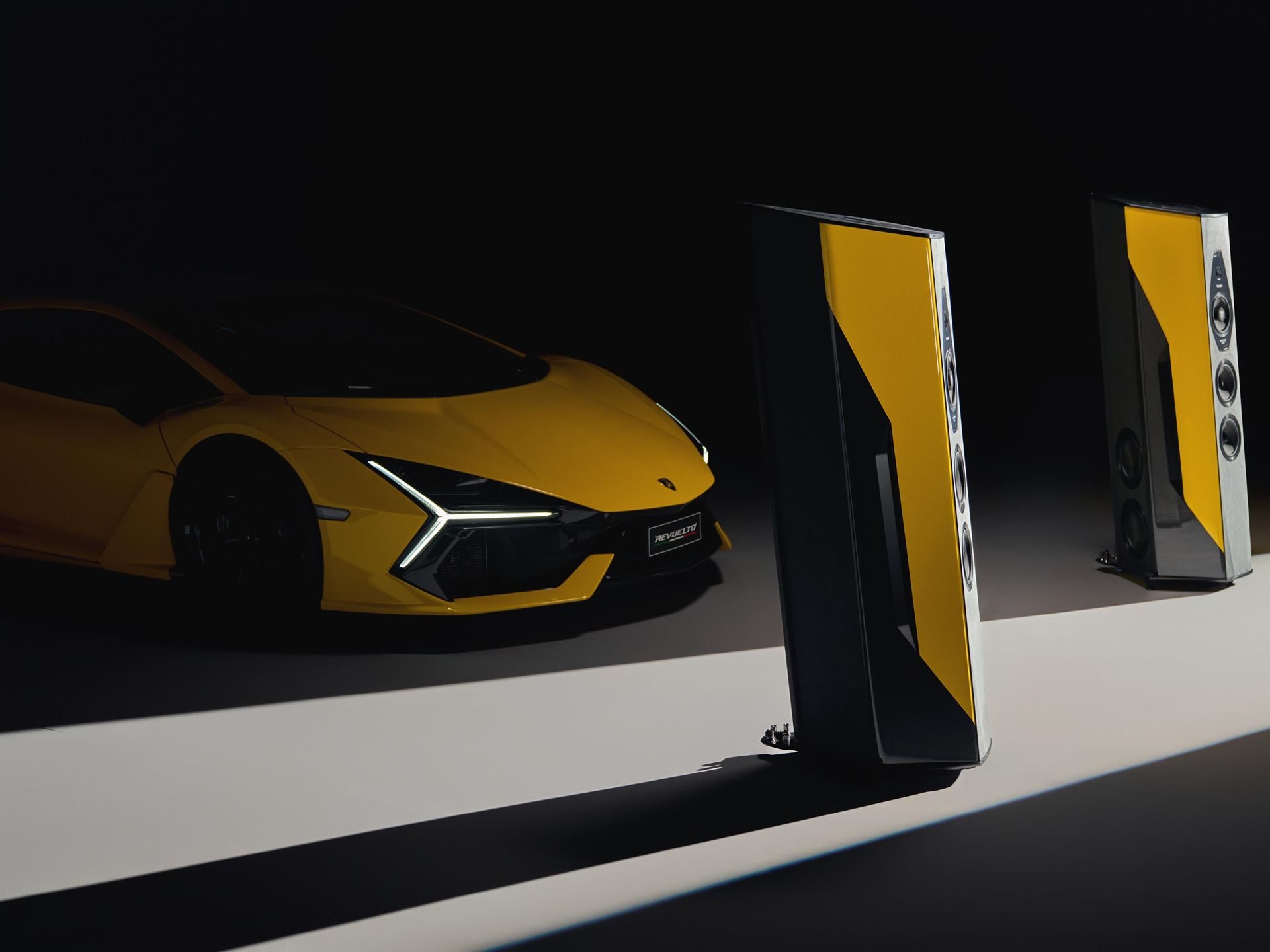 Lamborghini'S 2025 Holiday Gift Guide Stretches From Lego Bricks To $30,000 Loudspeakers 5 Yellow lamborghini revuelto positioned behind two sonus faber cremonese ex3me automobili lamborghini edition loudspeakers in a dramatic studio setting