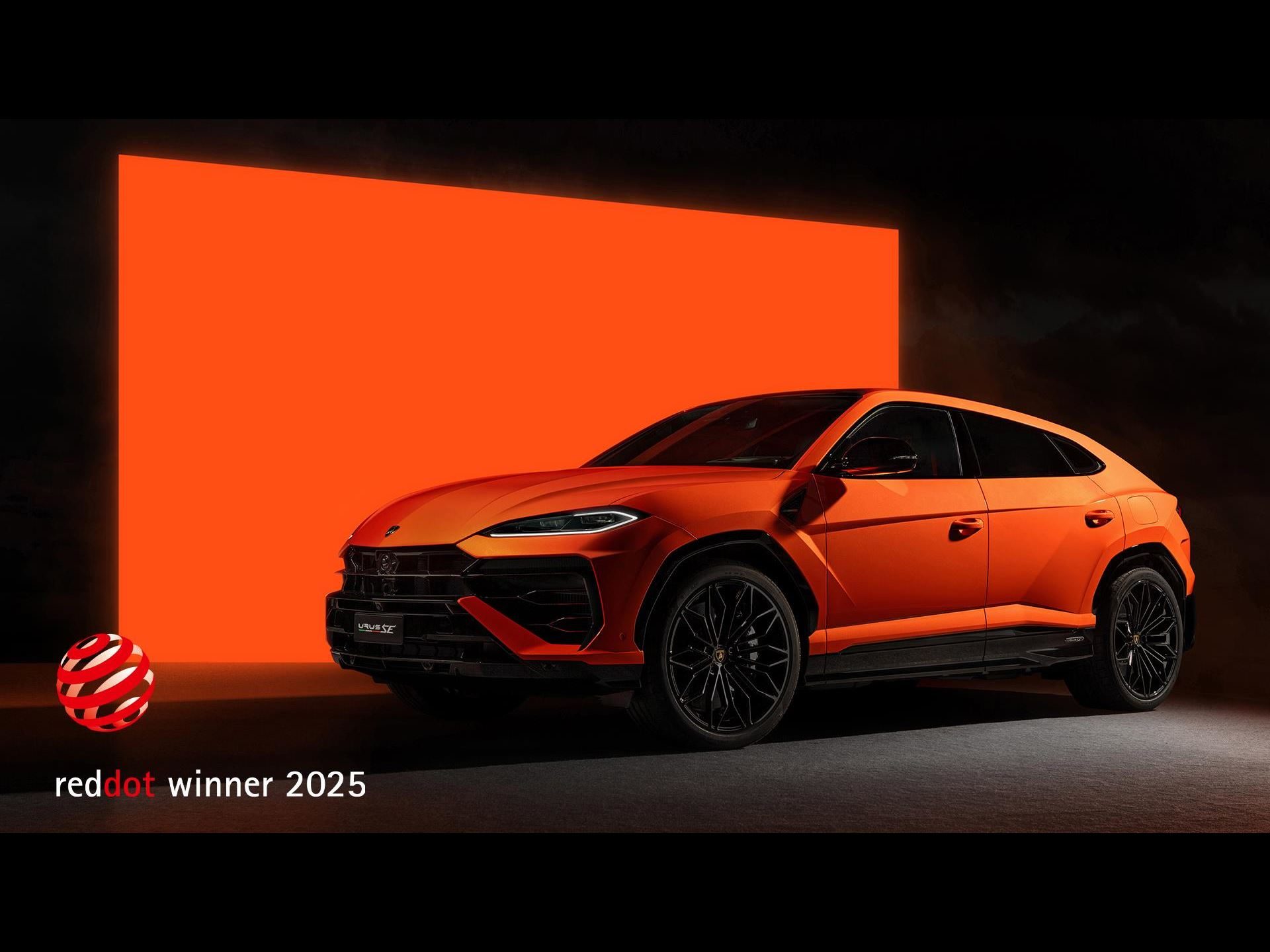 Every Lamborghini In The Lineup Just Won A Red Dot Award, And The Revuelto Took Top Honors 7 Orange lamborghini urus se in a dark studio with an orange illuminated backdrop, highlighting its aggressive suv stance
