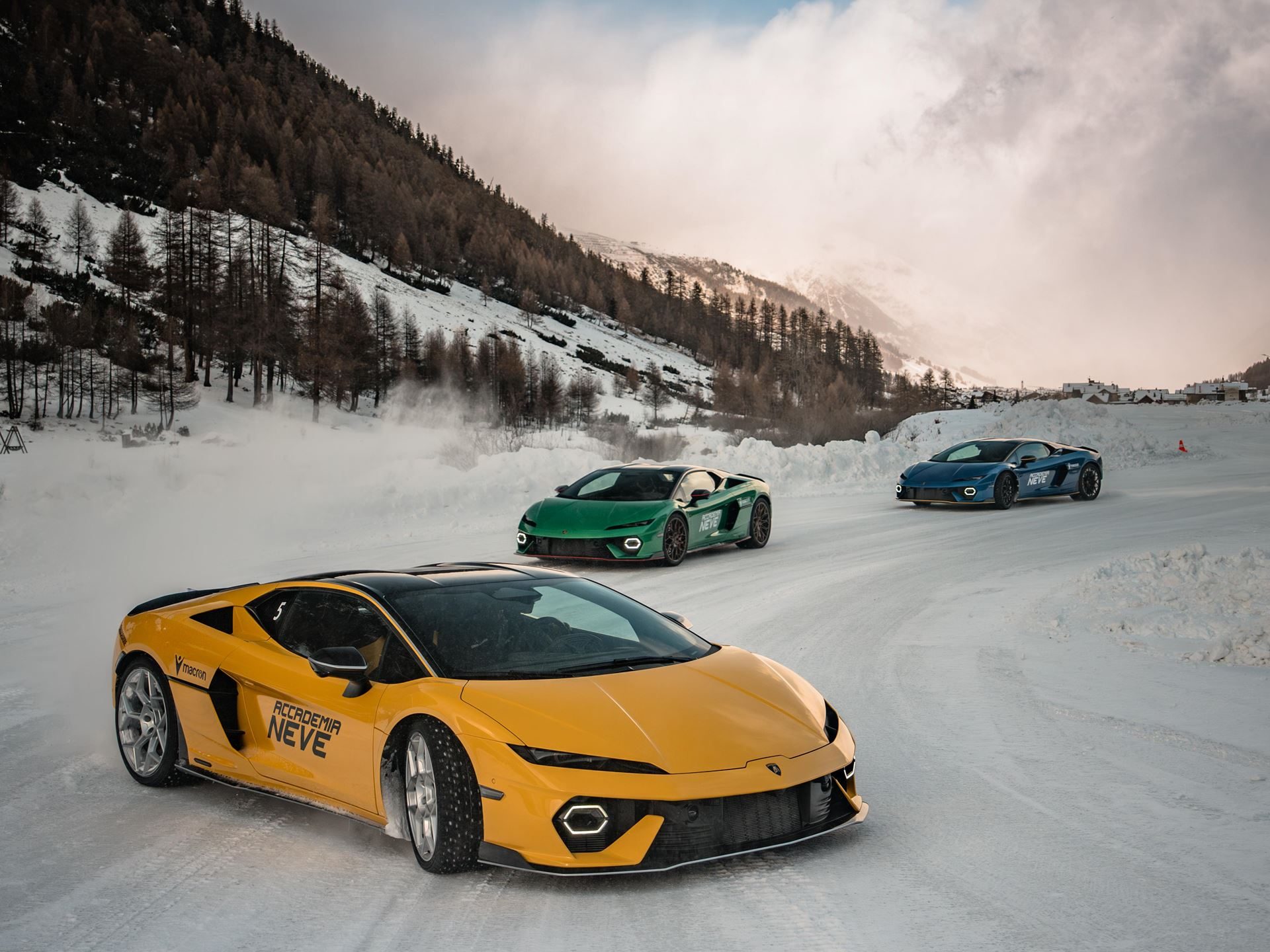 Accademia Neve 2026 Puts The Temerario On Ice, And Lamborghini'S Experiential Edge Over Rivals On Full Display 5 Three lamborghini huracán sterrato models in yellow, green, and blue driving on a snowy track with mountains behind