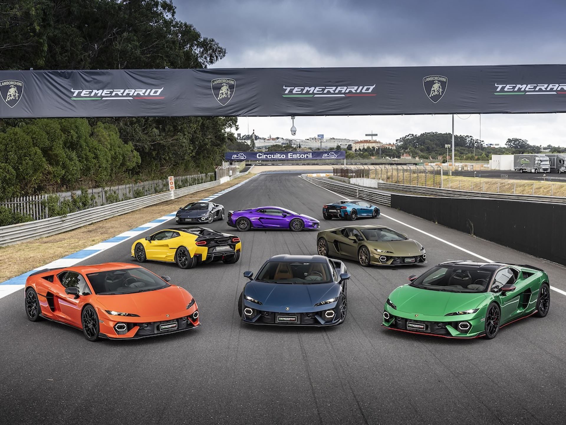 Why Lamborghini Names Its Paint Colors After Greek Gods And Diamond Dust 15 Multiple lamborghini revuelto models in various vibrant ad personam colors parked on a racetrack with temerario banners in background