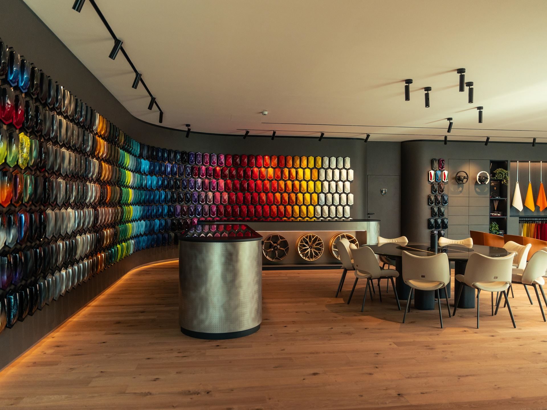 Why Lamborghini Names Its Paint Colors After Greek Gods And Diamond Dust 13 Wide shot of the lamborghini ad personam studio with curved wall of paint samples and consultation area