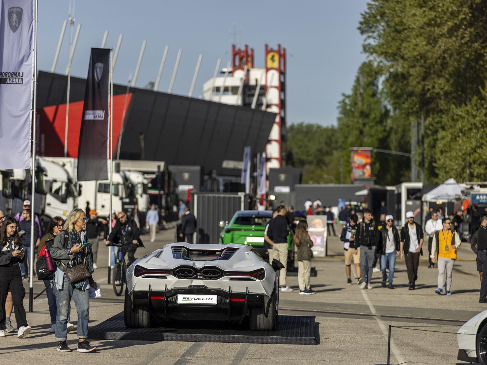 Lamborghini Arena Turns Imola Into A Brand Theme Park, While The Revuelto Sv Lurks Nearby 7 White lamborghini revuelto displayed on a raised platform at the lamborghini arena event, showing its aggressive rear diffuser and y-shaped taillights