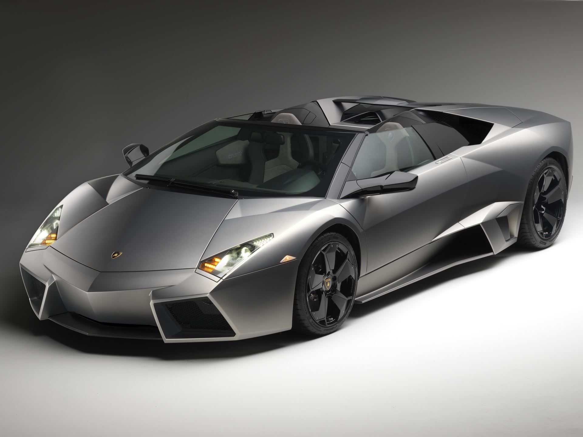 How One Decision In 2003 Gave Lamborghini Total Control Over Its Design Destiny 7 Matte grey lamborghini reventón roadster in a studio setting, showcasing its stealth-fighter-inspired design