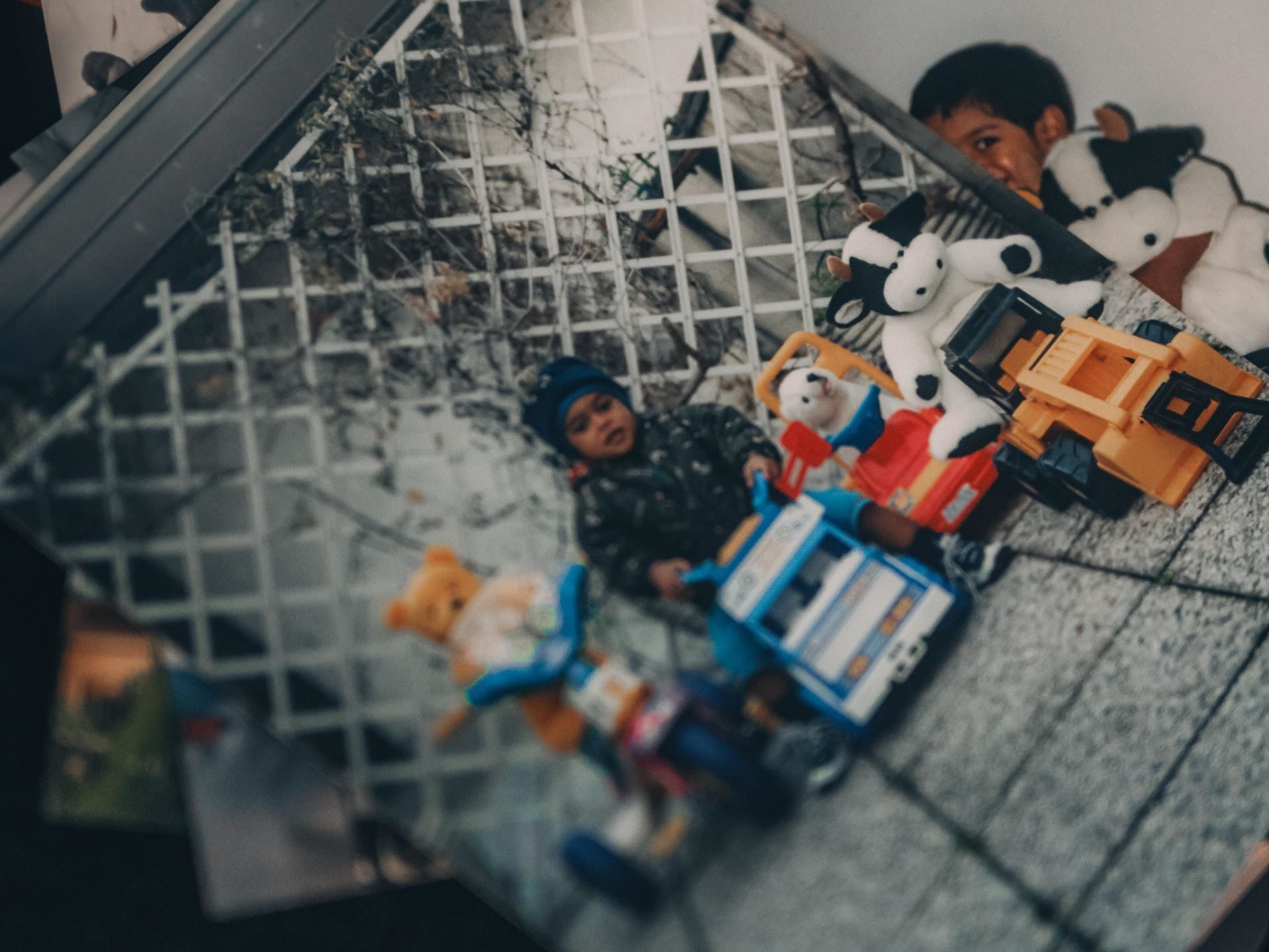 Lamborghini'S 2025 Christmas Video 'The Dinner' Puts Its Own Employees Center Stage 3 Overhead shot of old photographs showing a young child playing with toy vehicles, representing the childhood memories of a lamborghini employee