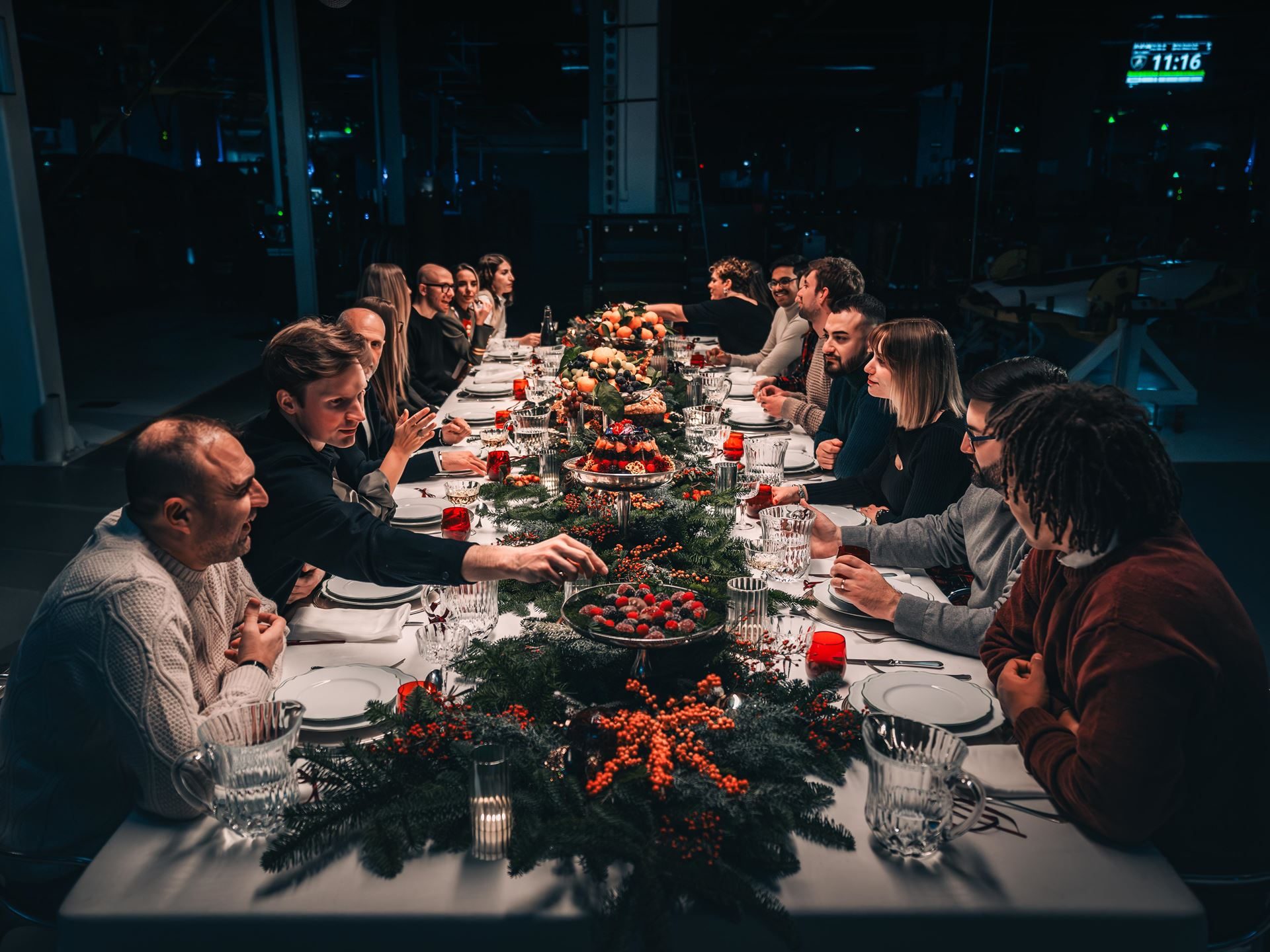 Lamborghini'S 2025 Christmas Video 'The Dinner' Puts Its Own Employees Center Stage 5 Long shot of lamborghini employees gathered around a large festively decorated dinner table laden with food and drinks