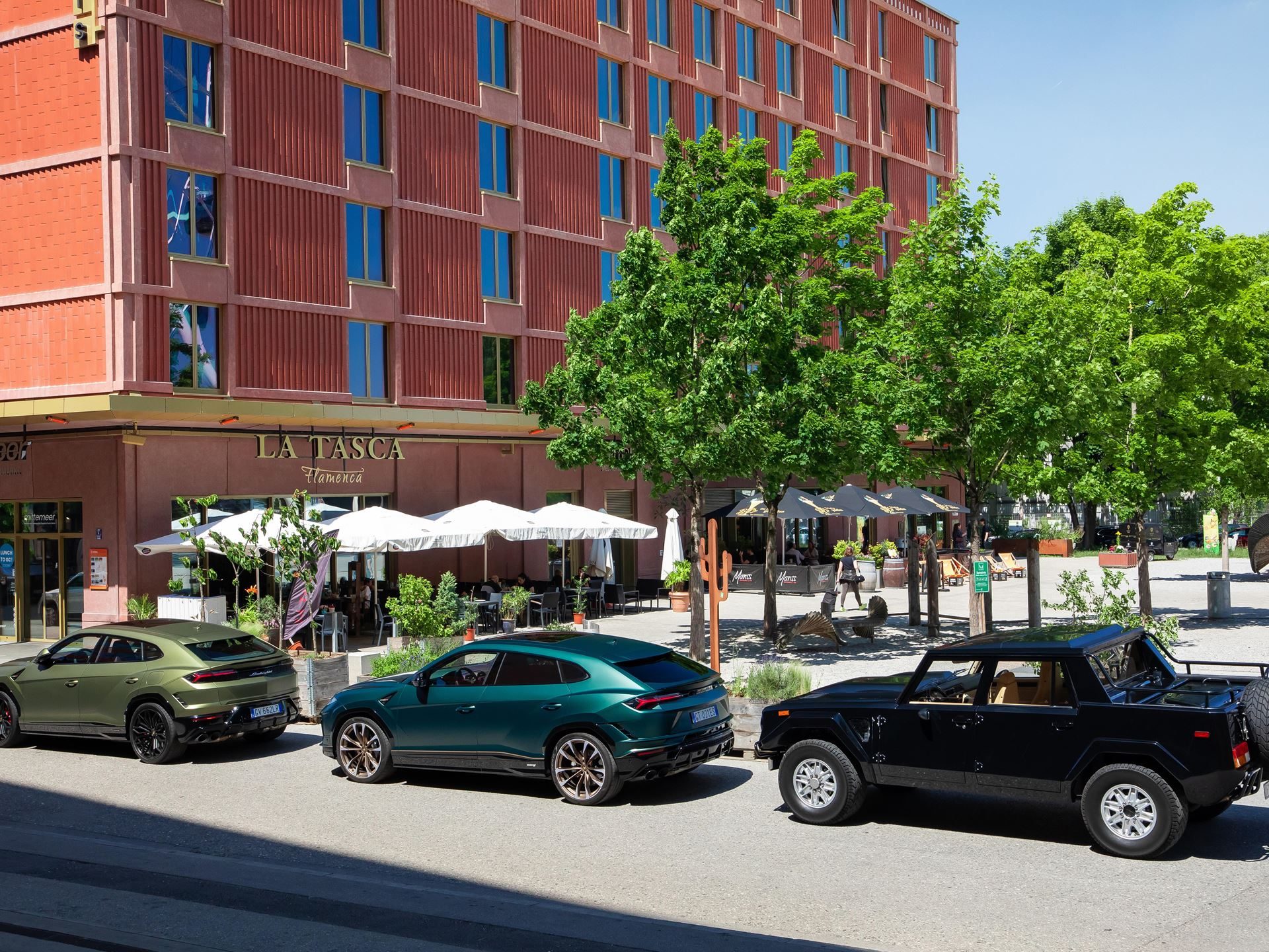 Lamborghini Day Germany 2025 Puts The Fully Electrified Lineup On Display In Munich 3 Three lamborghini suvs parked in a row on a munich street: two modern urus models and one classic black lm002