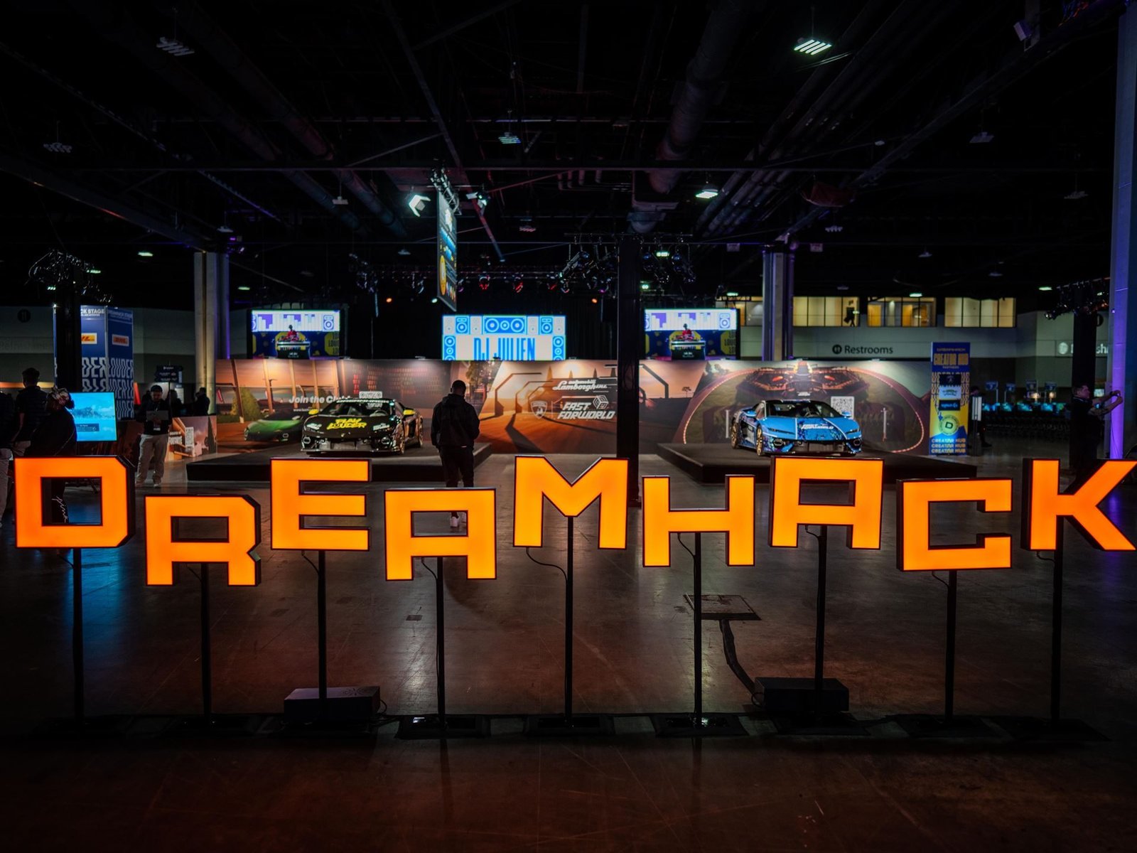 Wide shot of the DreamHack Atlanta event floor with illuminated DREAMHACK letters and custom Lamborghini Temerarios on display