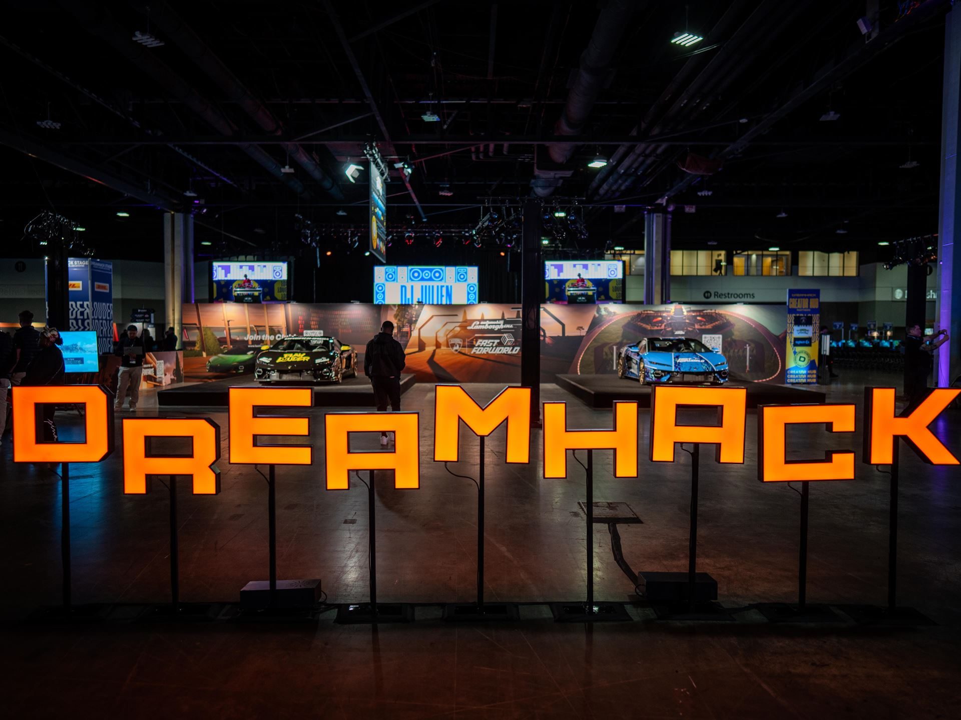 Wide shot of the dreamhack atlanta event floor with illuminated dreamhack letters and custom lamborghini temerarios on display