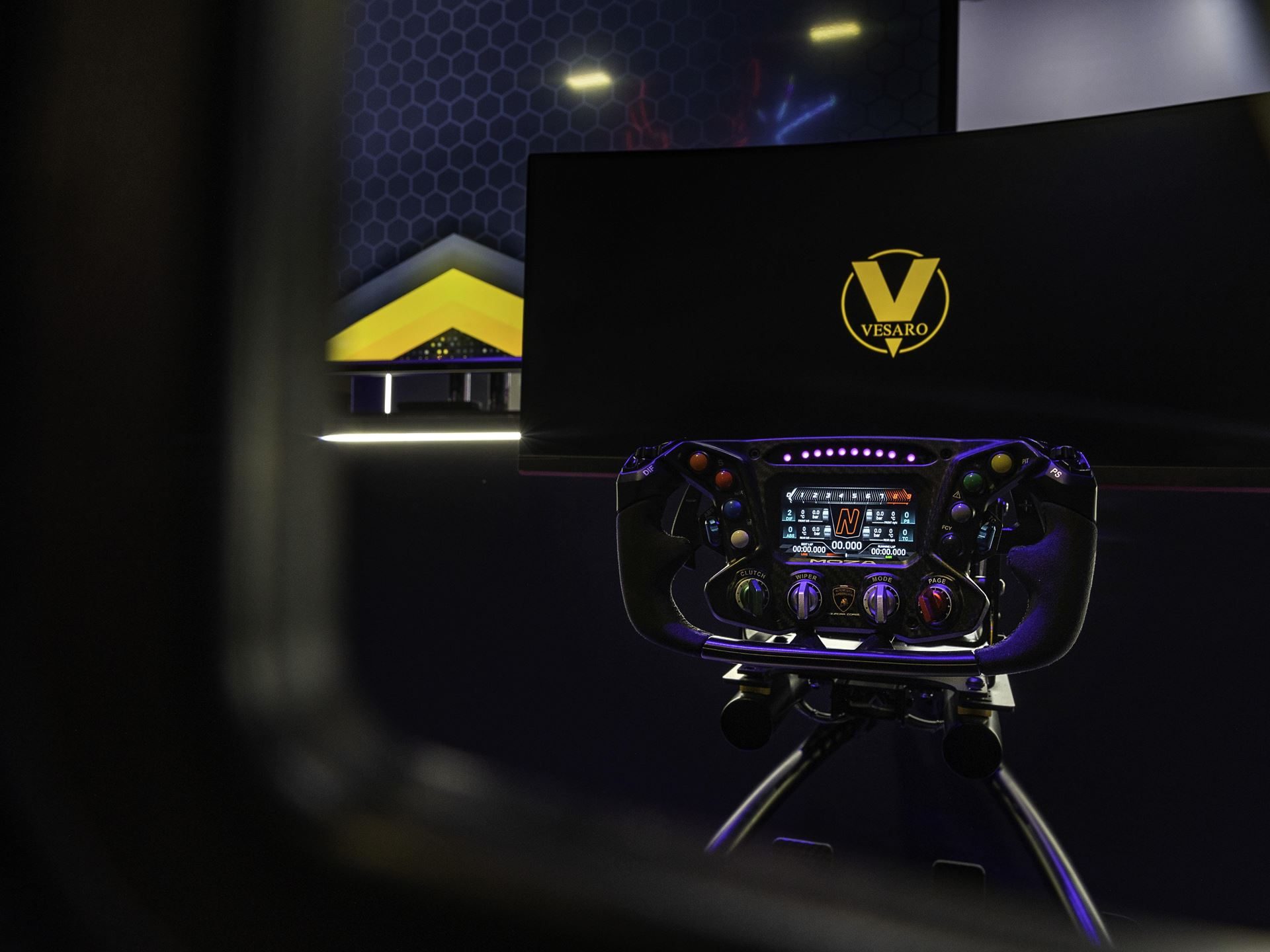 Lamborghini Crashed A Gaming Festival With A 1015 Hp Revuelto, Racing Simulators, And A Plan To Win Over A New Generation 5 Close-up of a vesaro-branded racing simulator steering wheel with multiple buttons and digital display at lamborghini's dreamhack dallas booth