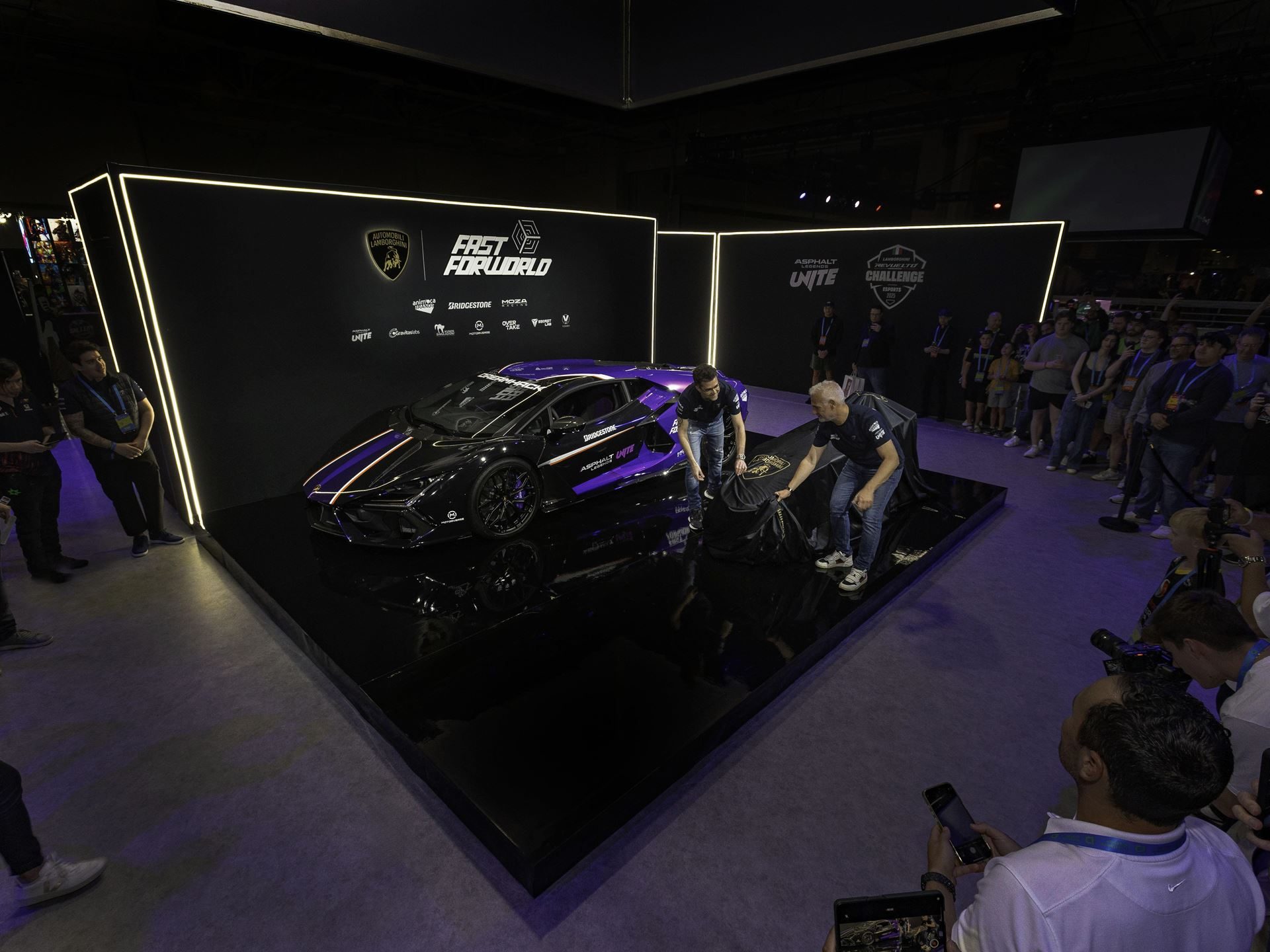 Lamborghini Crashed A Gaming Festival With A 1015 Hp Revuelto, Racing Simulators, And A Plan To Win Over A New Generation 9 Lamborghini booth at dreamhack dallas 2025 with crowd gathered around the display area