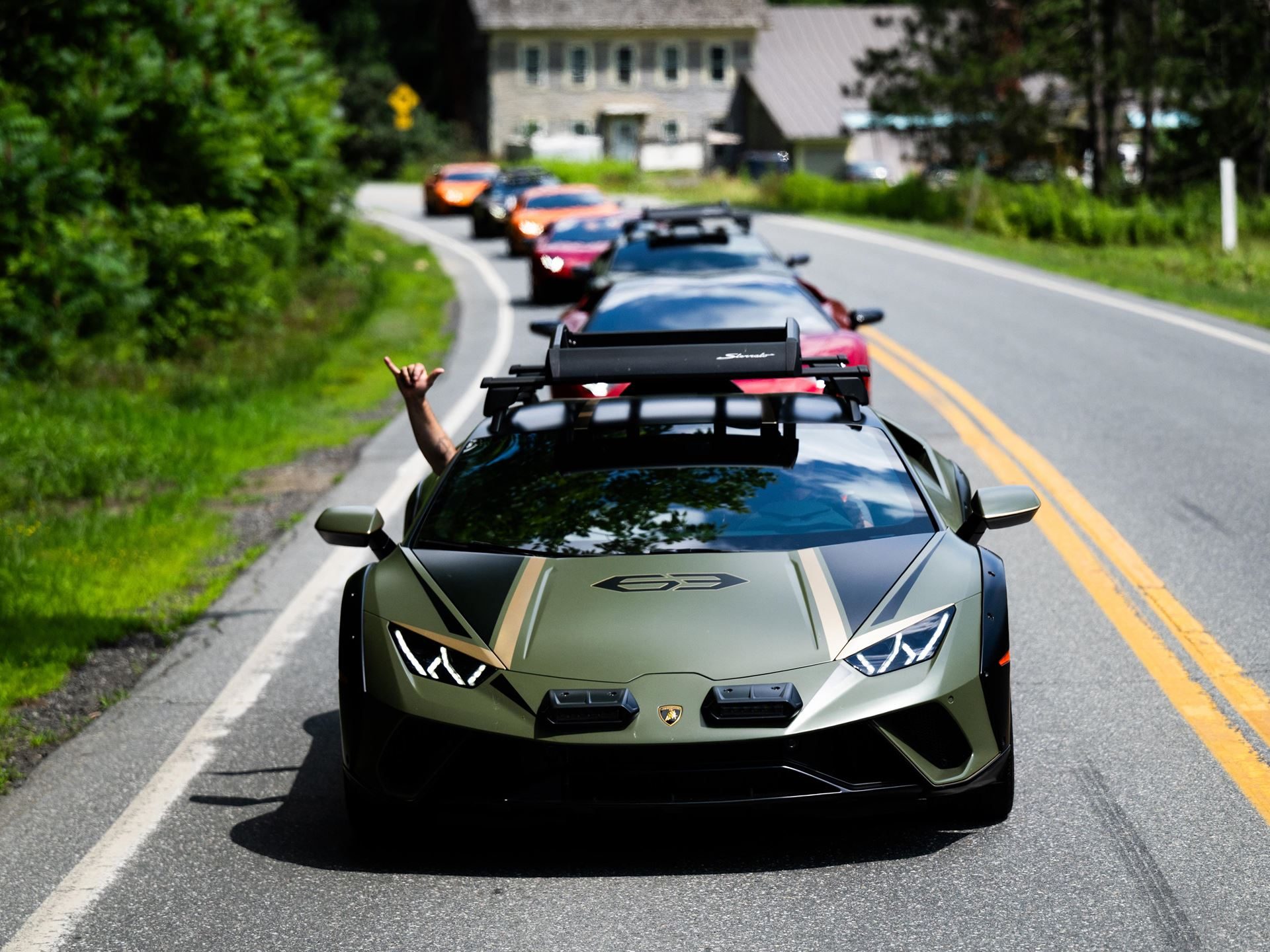449 Miles Of New England Back Roads With 30 Lamborghinis: Inside The Esperienza Giro Usa 11 A matte green lamborghini huracán sterrato with roof racks leads a convoy on an open road