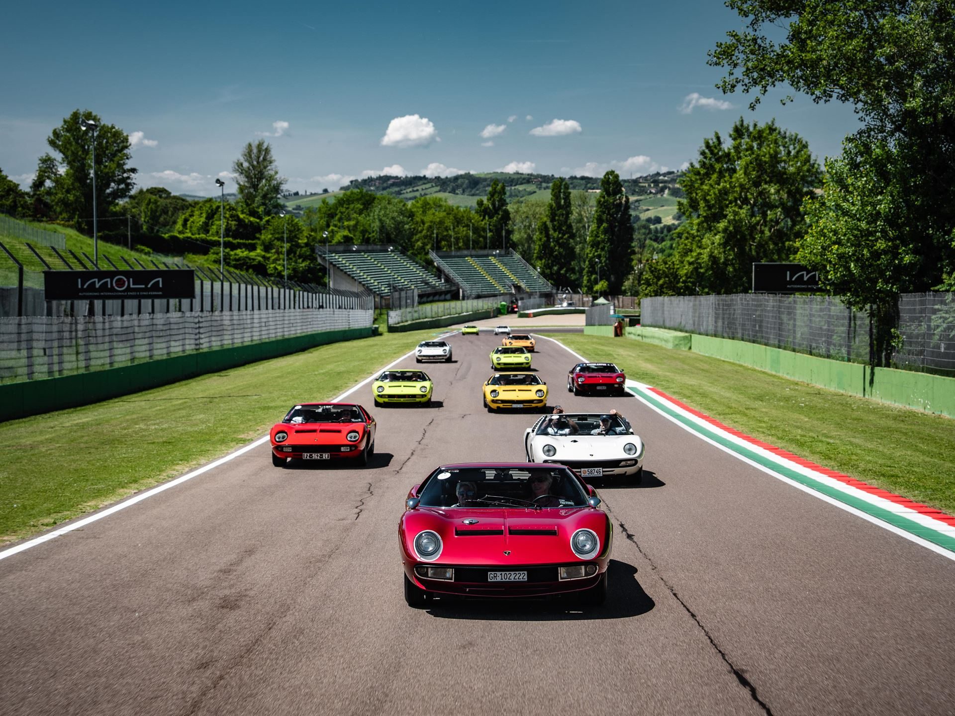 Fenomeno Roadster: 15 Units Of 1,080 Cv Open-Top V12 Fury Headline Lamborghini Arena 2026 9 A convoy of classic lamborghini miuras in multiple colors driving on the imola circuit during the 60th anniversary celebration
