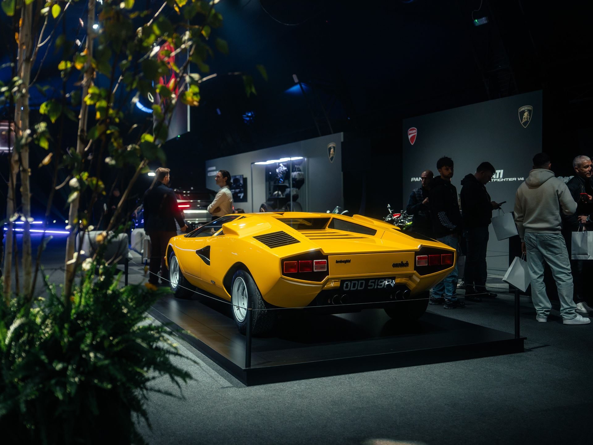 Lamborghini Day Uk Puts The Sold-Out Fenomeno And Drivable Temerario In Front Of 300 Owners At Millbrook 7 Classic yellow 1976 lamborghini countach lp 400 displayed on a raised platform at lamborghini day uk