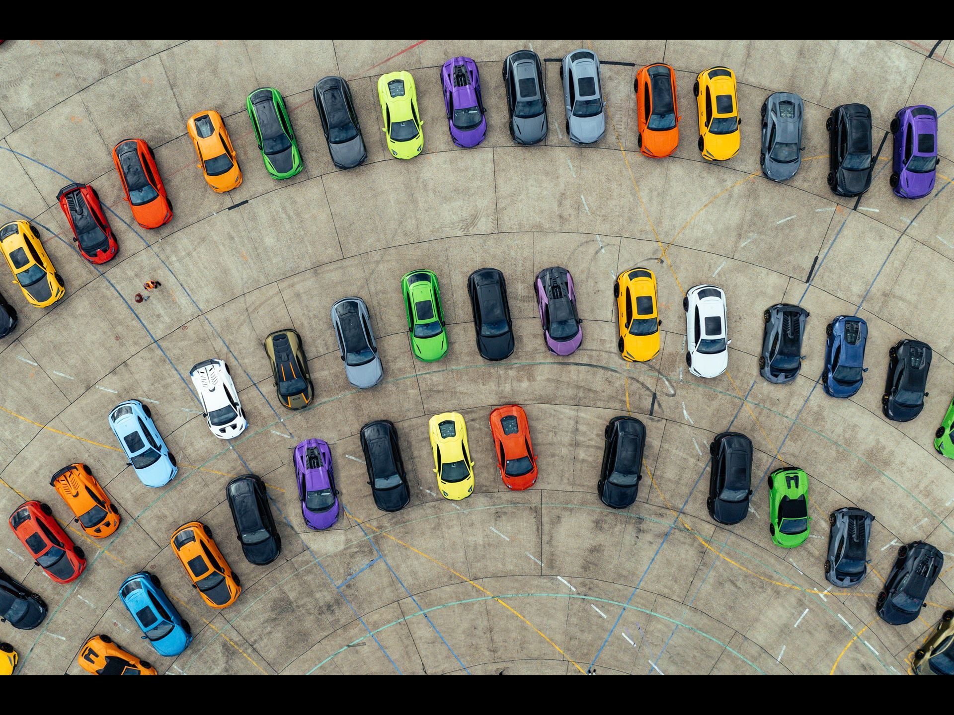 Lamborghini Day Uk Puts The Sold-Out Fenomeno And Drivable Temerario In Front Of 300 Owners At Millbrook 11 Aerial view of numerous colorful lamborghini cars parked in concentric arcs at lamborghini day uk 2025