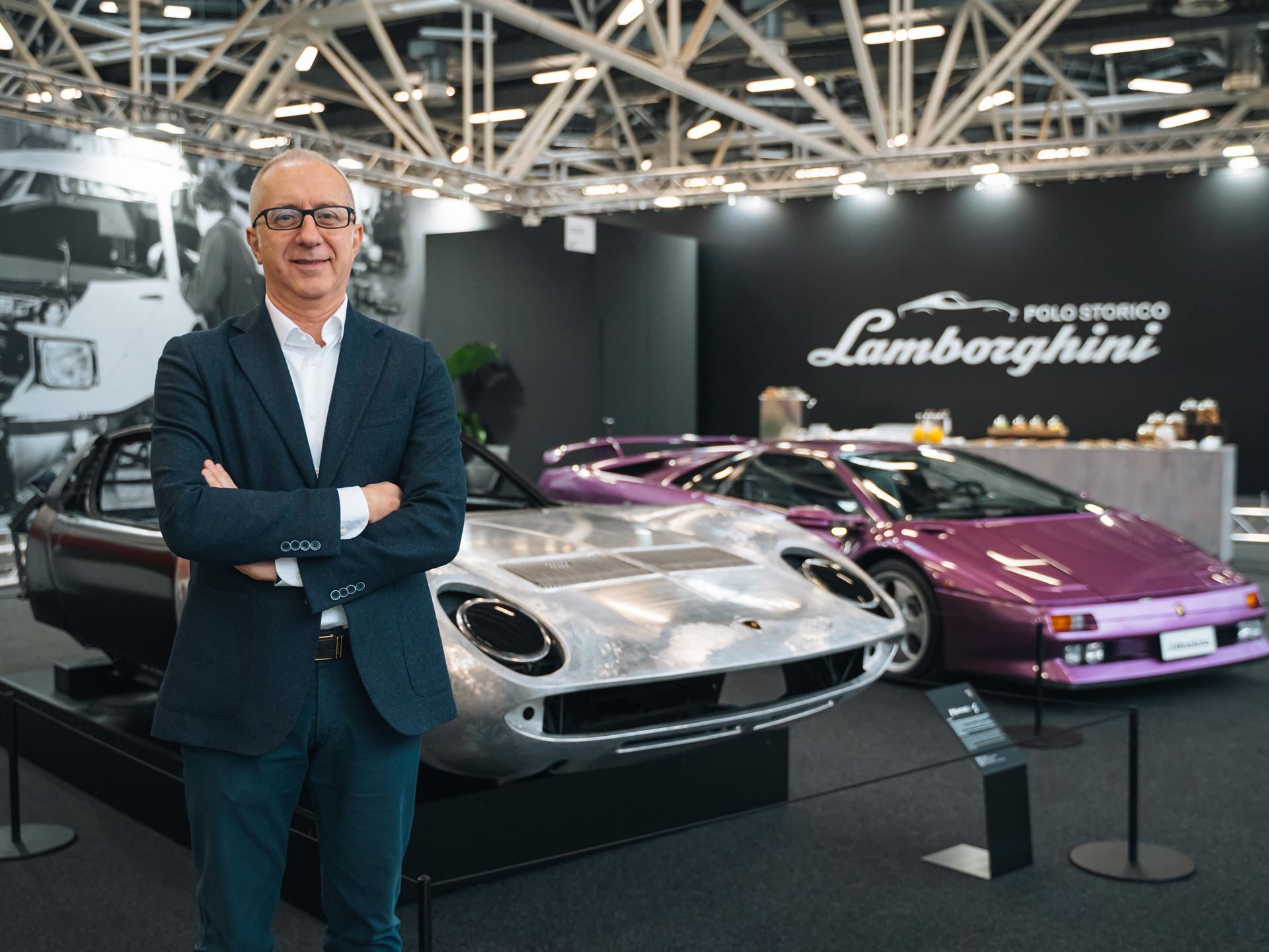 Lamborghini'S New 'Alternative Fuels' Role Signals What Comes After Hybridization 7 Alessandro farmeschi standing in front of a silver miura and purple diablo at a lamborghini polo storico event
