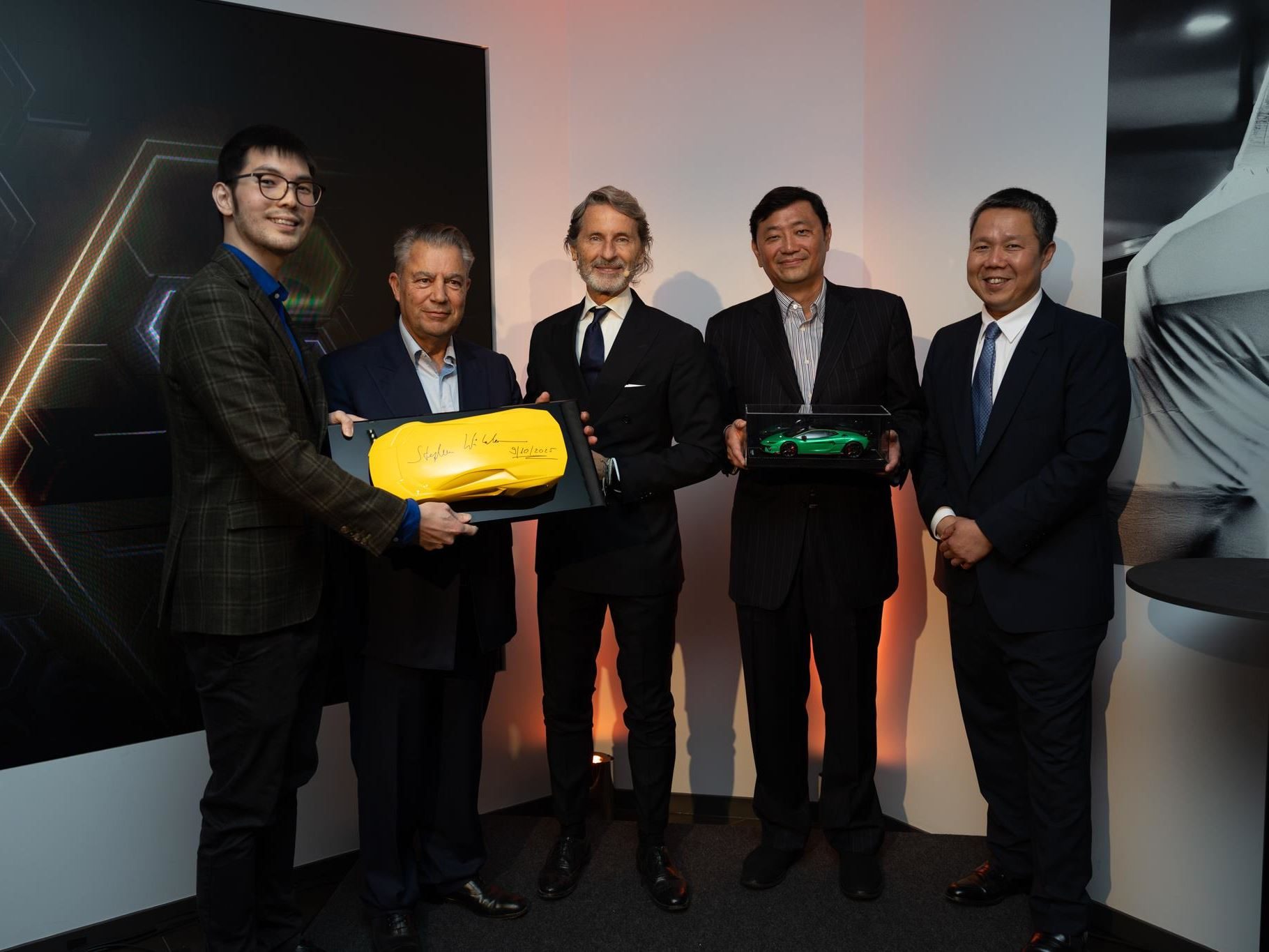 Lamborghini Plants Its Hybrid-Era Flag In Berkeley Square With Europe'S Most Extensive Ad Personam Display 9 Five executives in suits posing at the lamborghini mayfair opening, holding scale model lamborghinis