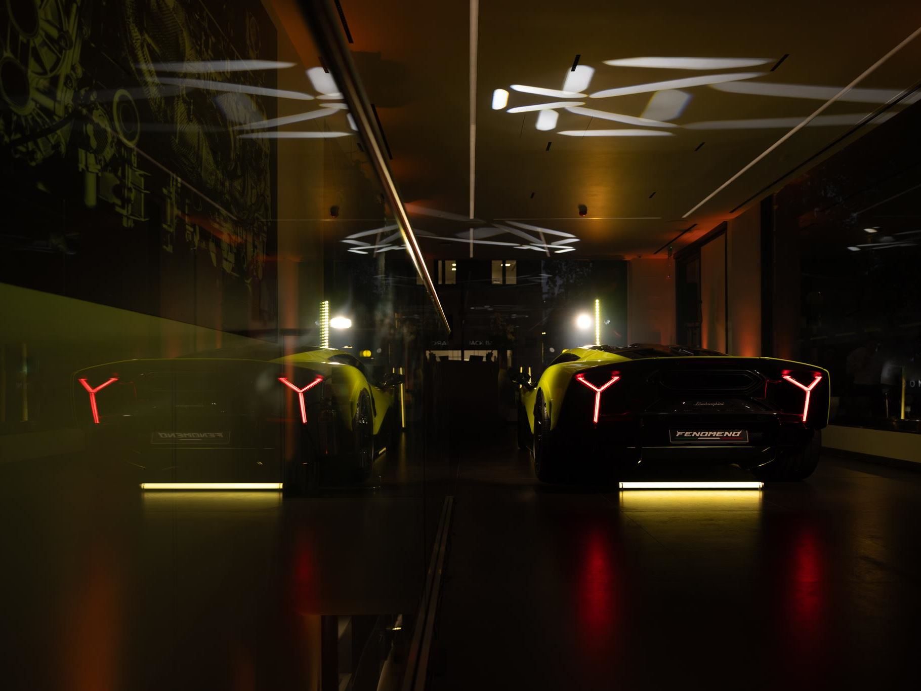 Lamborghini Plants Its Hybrid-Era Flag In Berkeley Square With Europe'S Most Extensive Ad Personam Display 7 Two lamborghini revuelto models, one yellow and one black, displayed in the mayfair showroom with distinctive y-shaped taillights visible